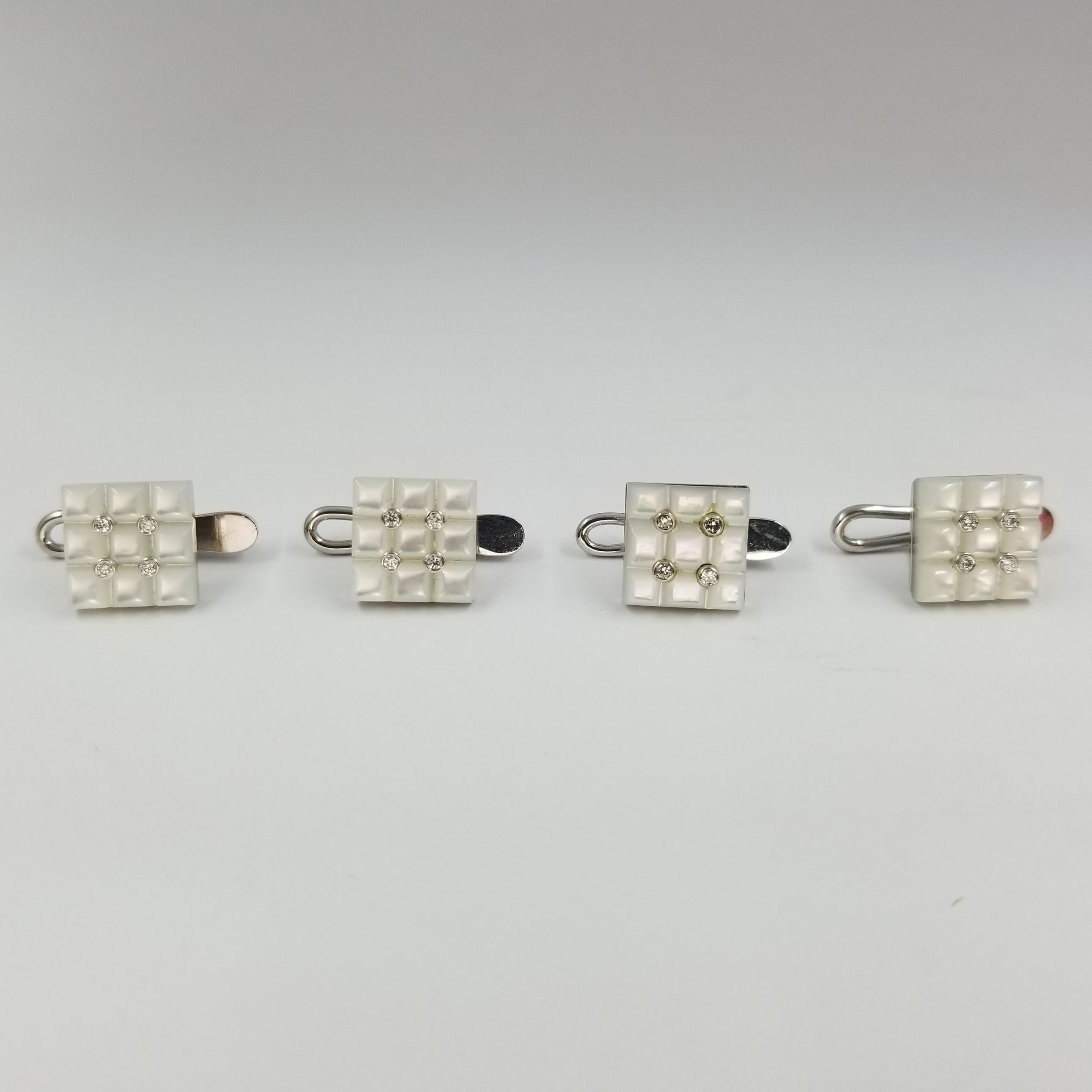 Set of 4 Tuxedo Shirt Studs crafted in 18 karat white gold (stamped 750), carved mother of pearl, and bezel set diamonds. 16 round diamonds of VS clarity & G color total approximately 0.16cttw. Hinged backs for easy dressing and removal.