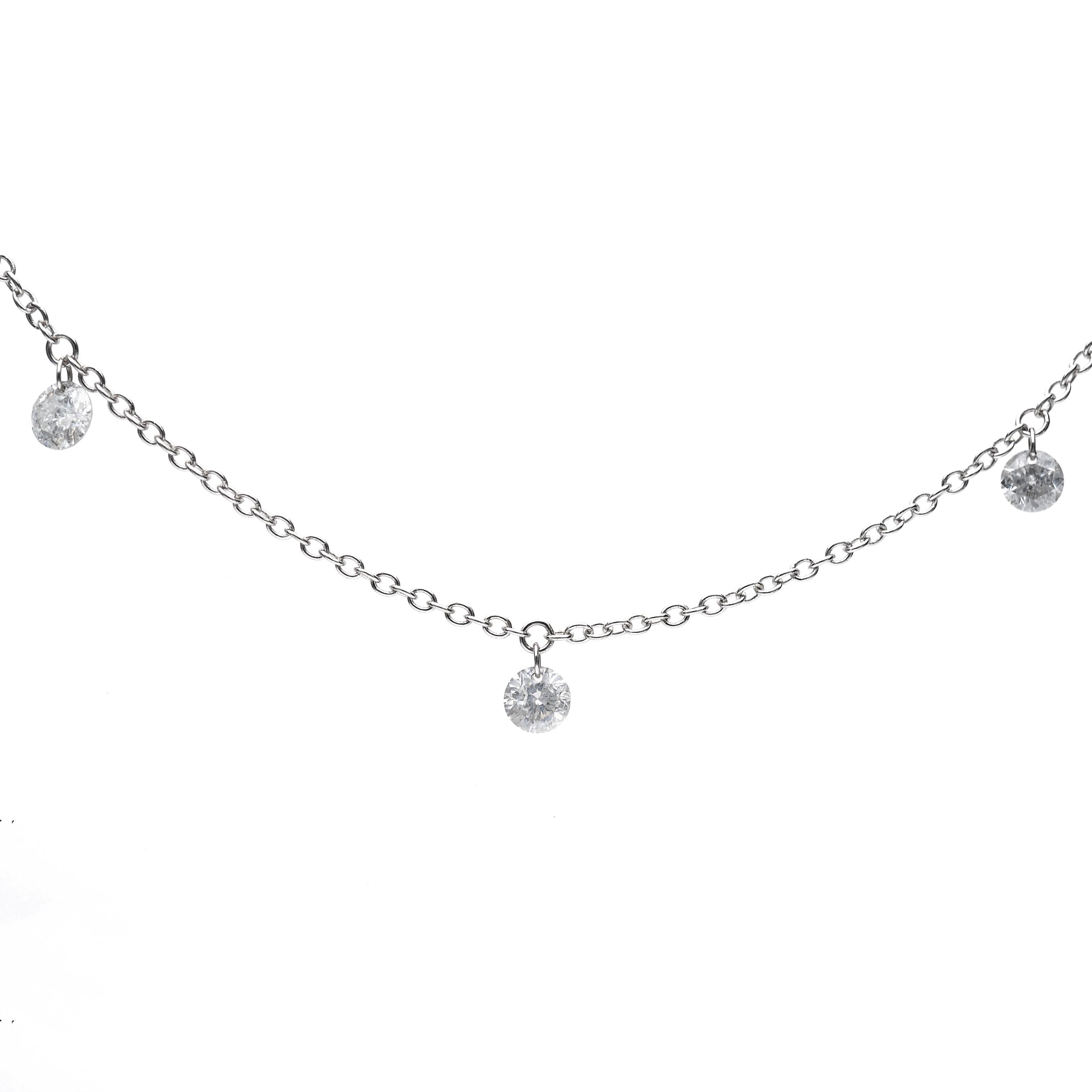 The thin necklace in 18 Kt white gold has seven pendants of brilliant cut diamonds, their total weight is 
ct. 1.16.
 Its peculiarity is that the diamonds are 