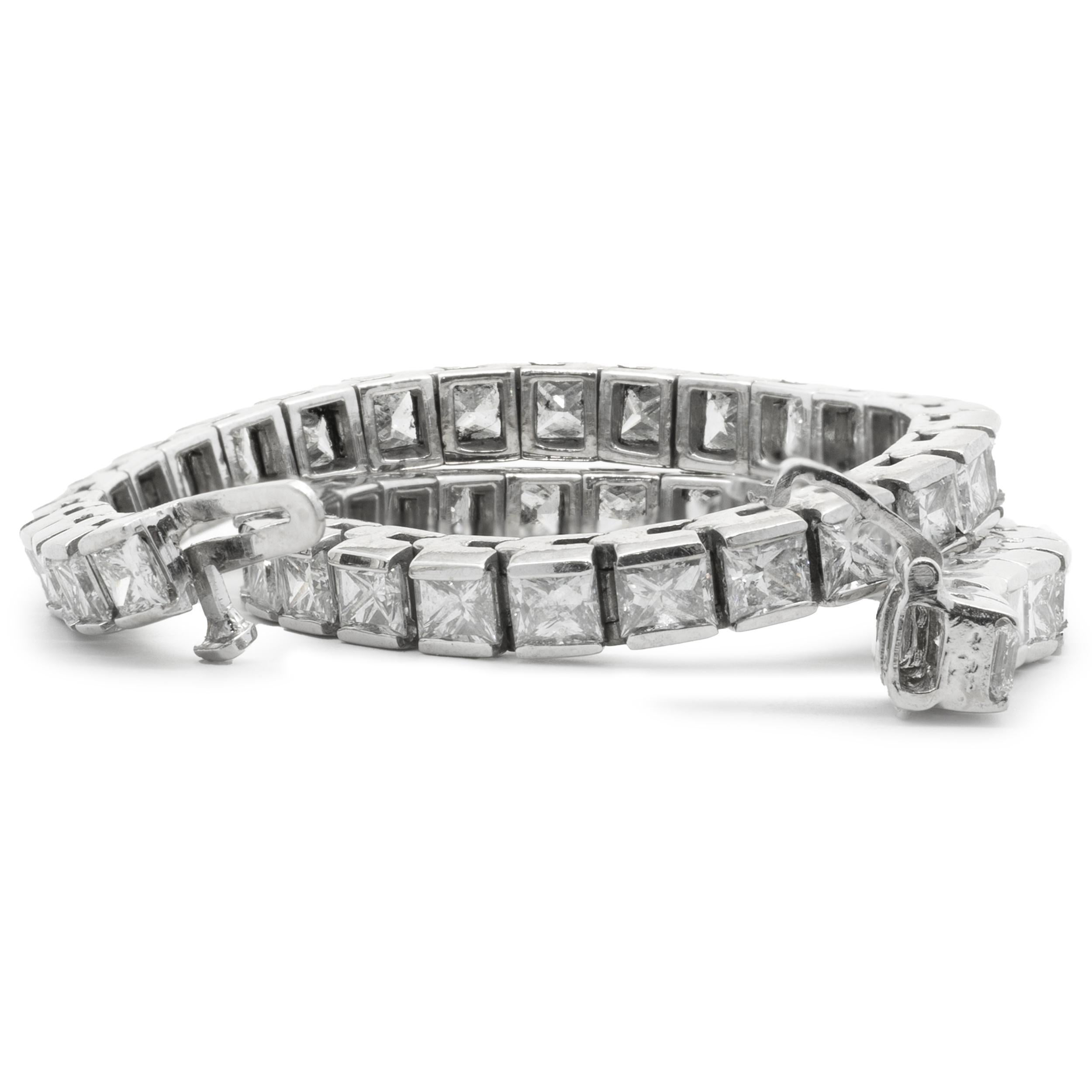 Designer: custom
Material: 18K white gold
Diamonds: 50 princess cut = 11.50cttw
Color: G
Clarity: SI1-2
Dimensions: bracelet will fit up to a 7-inch wrist
Weight: 16.28 grams