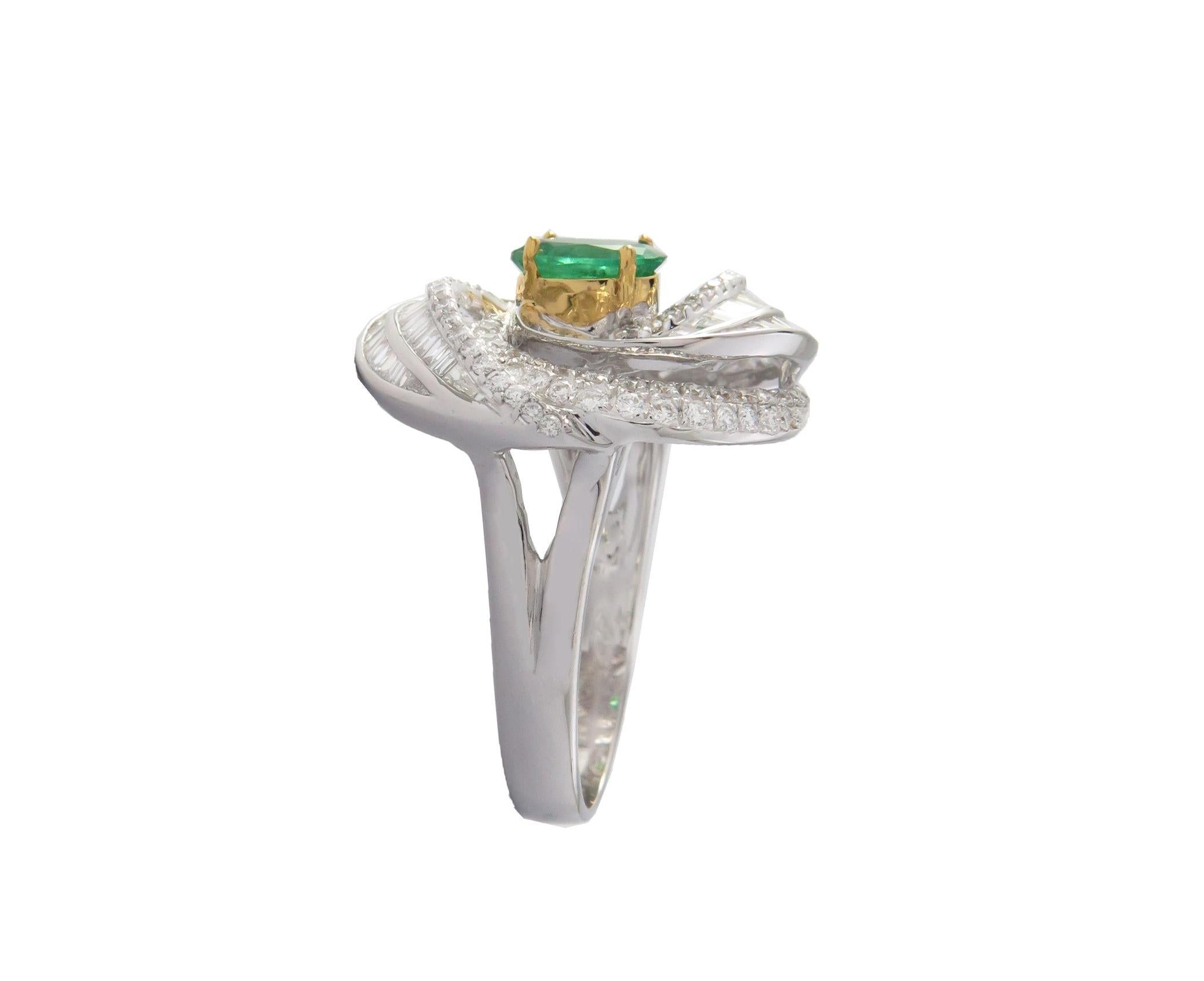 This 18K White Gold cocktail ring features a Baguette and Brilliant cut White Diamond with Beautiful Emerald Color Stone. Combine with glamorous outfits for a show-stopping effect. Each diamond hand-selected by our experts for its superior luster