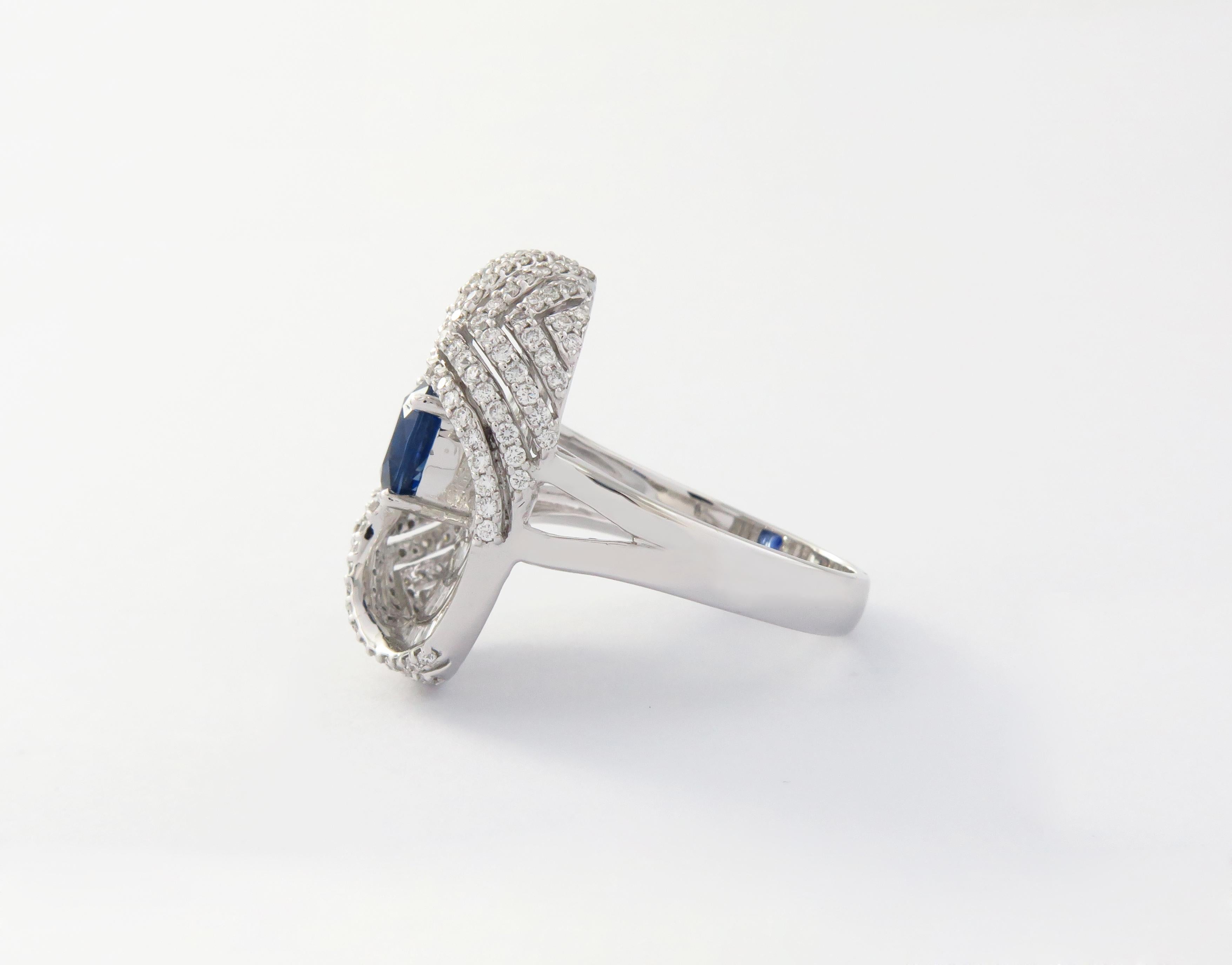 This 18K White Gold cocktail ring features a Baguette and Brilliant cut White Diamond with a Beautiful Shining Sapphire Color Stone. Combine with glamorous outfits for a show-stopping effect. Each diamond hand-selected by our experts for its