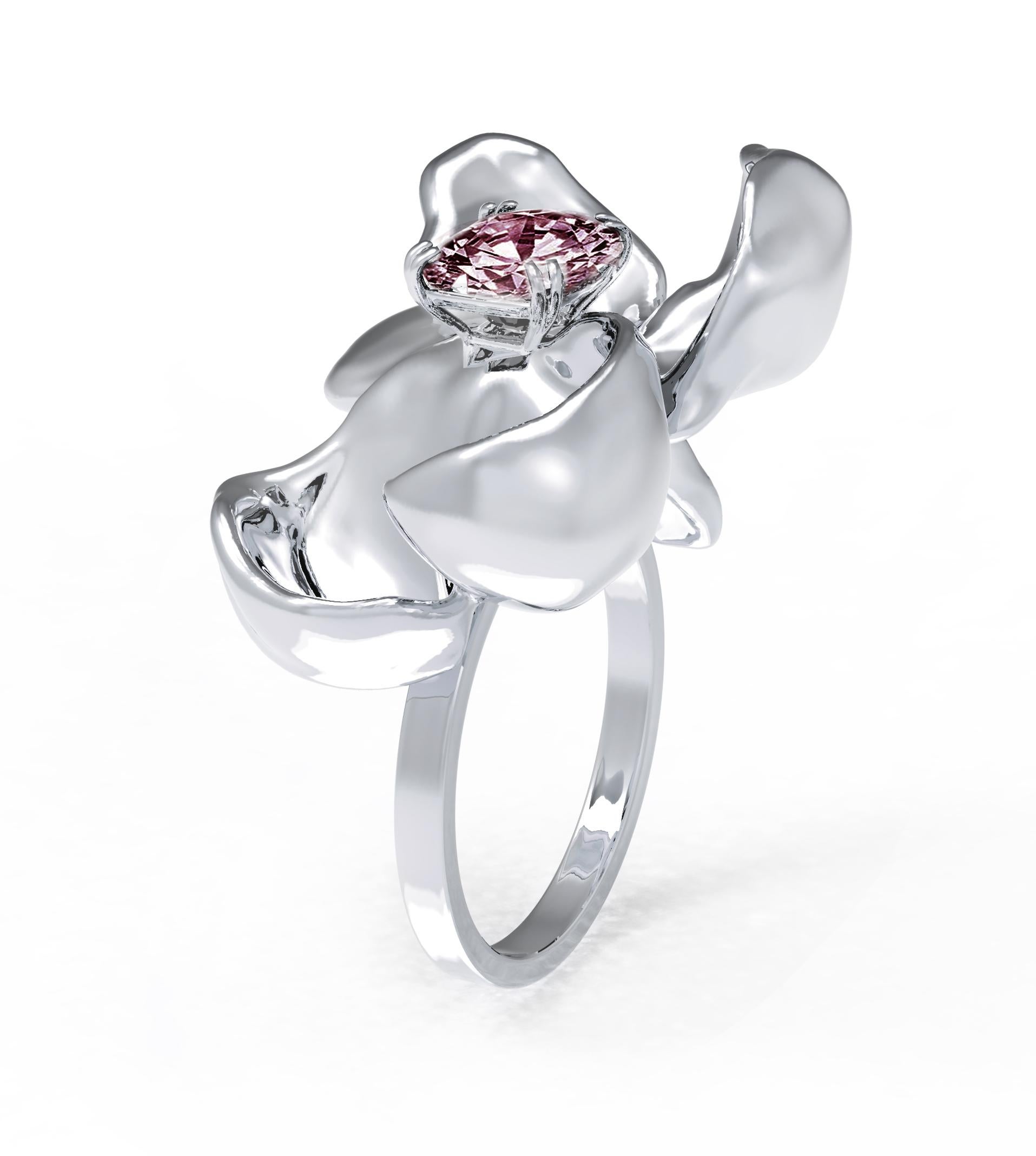 This contemporary Magnolia Flower cocktail ring is crafted in 18 karat white gold and features a stunning berry purple cushion spinel weighing 1.7 carats. The water-surface of the spinel amplifies the light, creating a stunning reflection on the