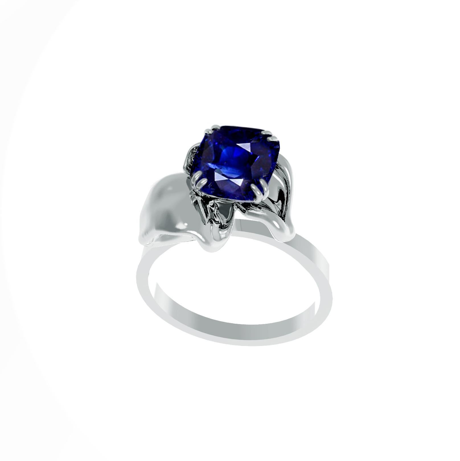 This contemporary cocktail ring is made of 18 karat white gold and is encrusted with a natural vivid blue great cut transparent cushion sapphire. The ring's unique design features a tiny flower shape that visually enhances the size of the gem,