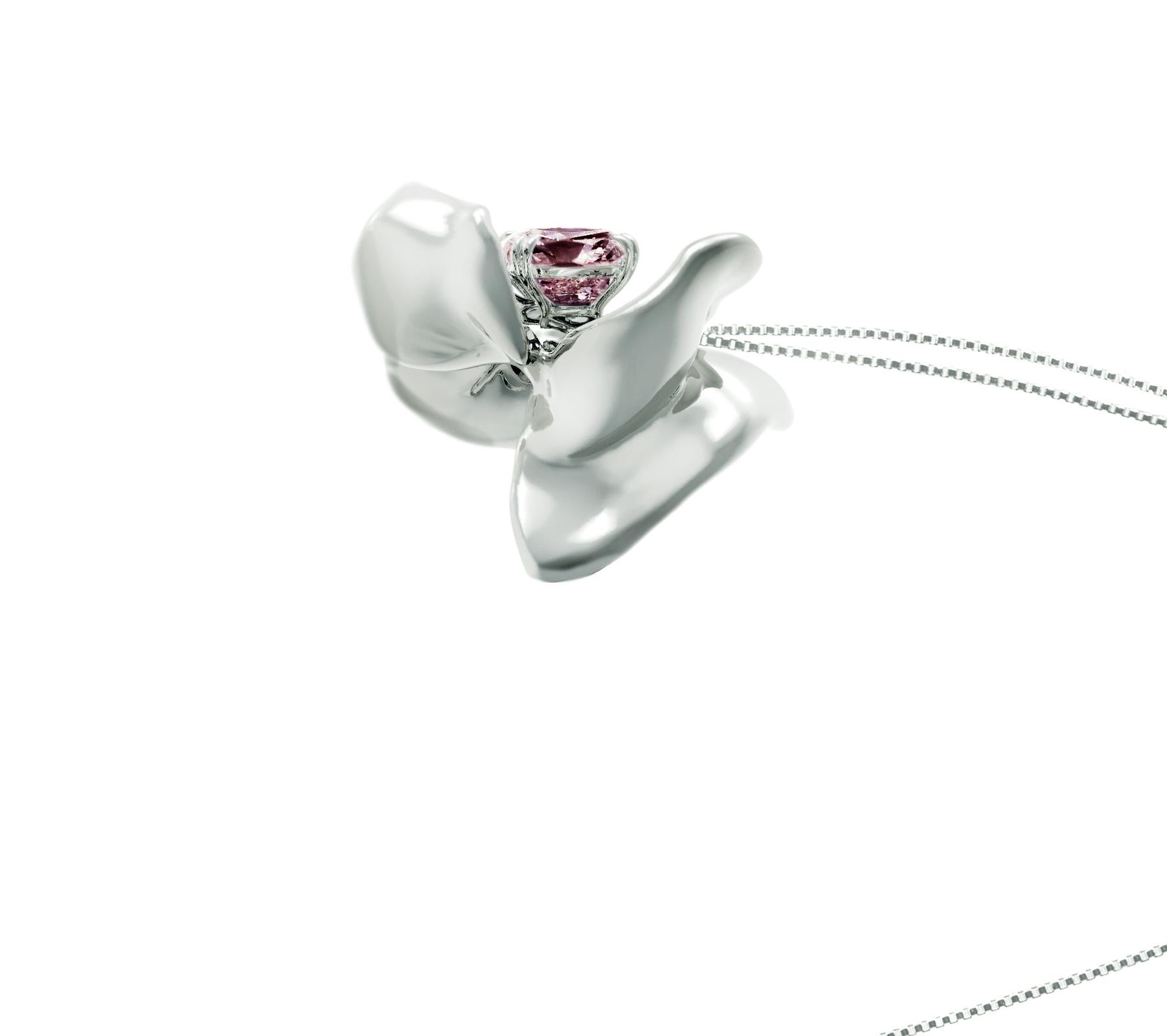 This Magnolia Flower contemporary pendant necklace is crafted in 18 karat white gold, with a storm purple cushion spinel weighing 1.34 carats. The tender water-surface of the spinel multiplies the light, mirroring on the golden petals. The pendant