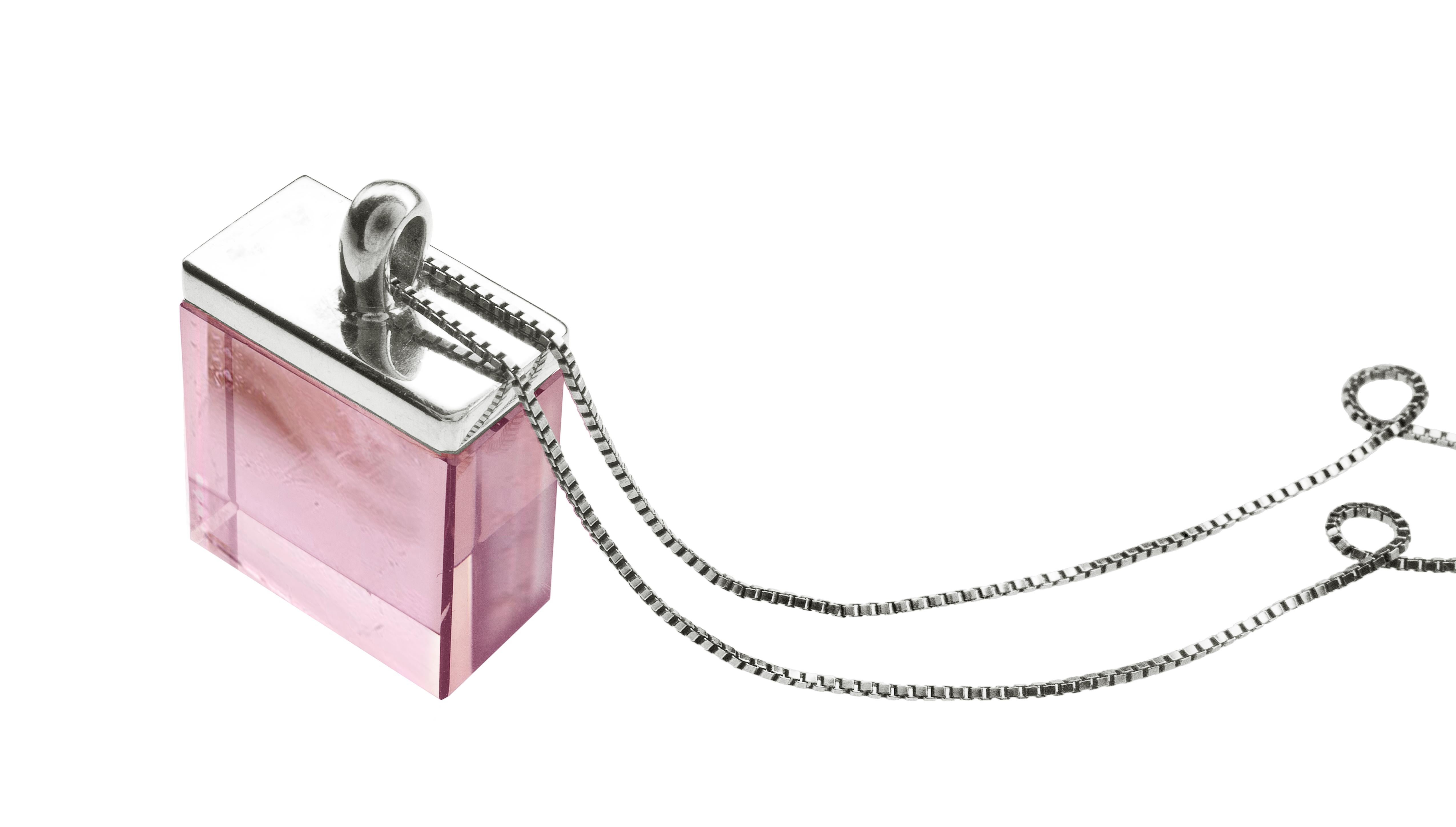This contemporary pendant necklace in 18 karat white gold features a specially cut 15x15x8 mm natural untreated transparent pink tourmaline, sourced from the gem company in Germany that has been in the market since the 19th century. The ring from