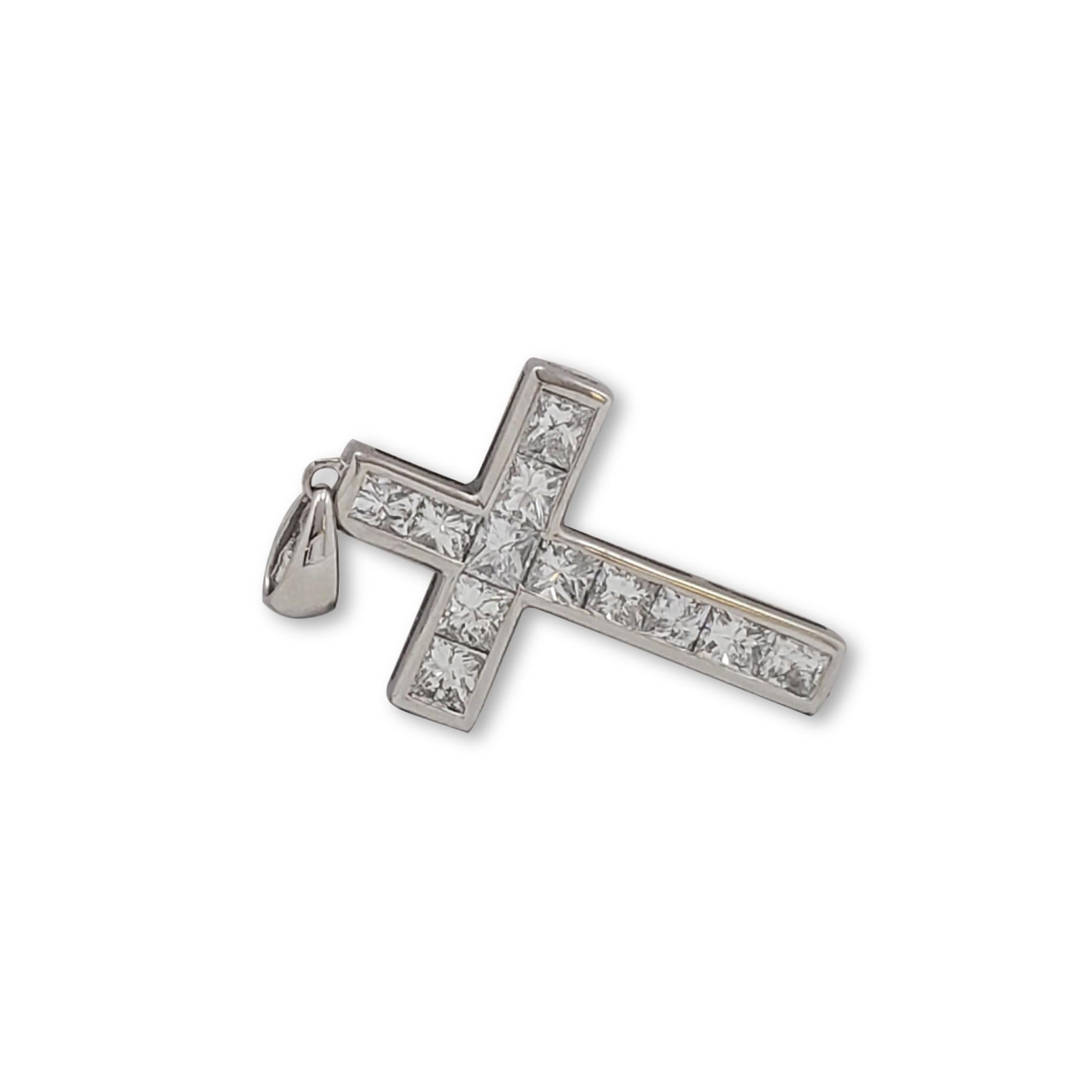 A charming cross pendant crafted in 18 karat white gold and set with an estimated 1.35 carats (G-I color, SI clarity) of princess cut diamonds.  The pendant measures .95 inches in length and .66 inches wide. CIRCA 2000s

Metal: 18k White