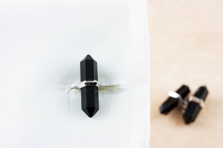 The timeless color combination of black and white gives this pair of cufflinks a sophisticated and striking appearance. 
The identical front face and toggle are shaped as elongated hexagons made of onyx, while the post is in 18 karat white gold.