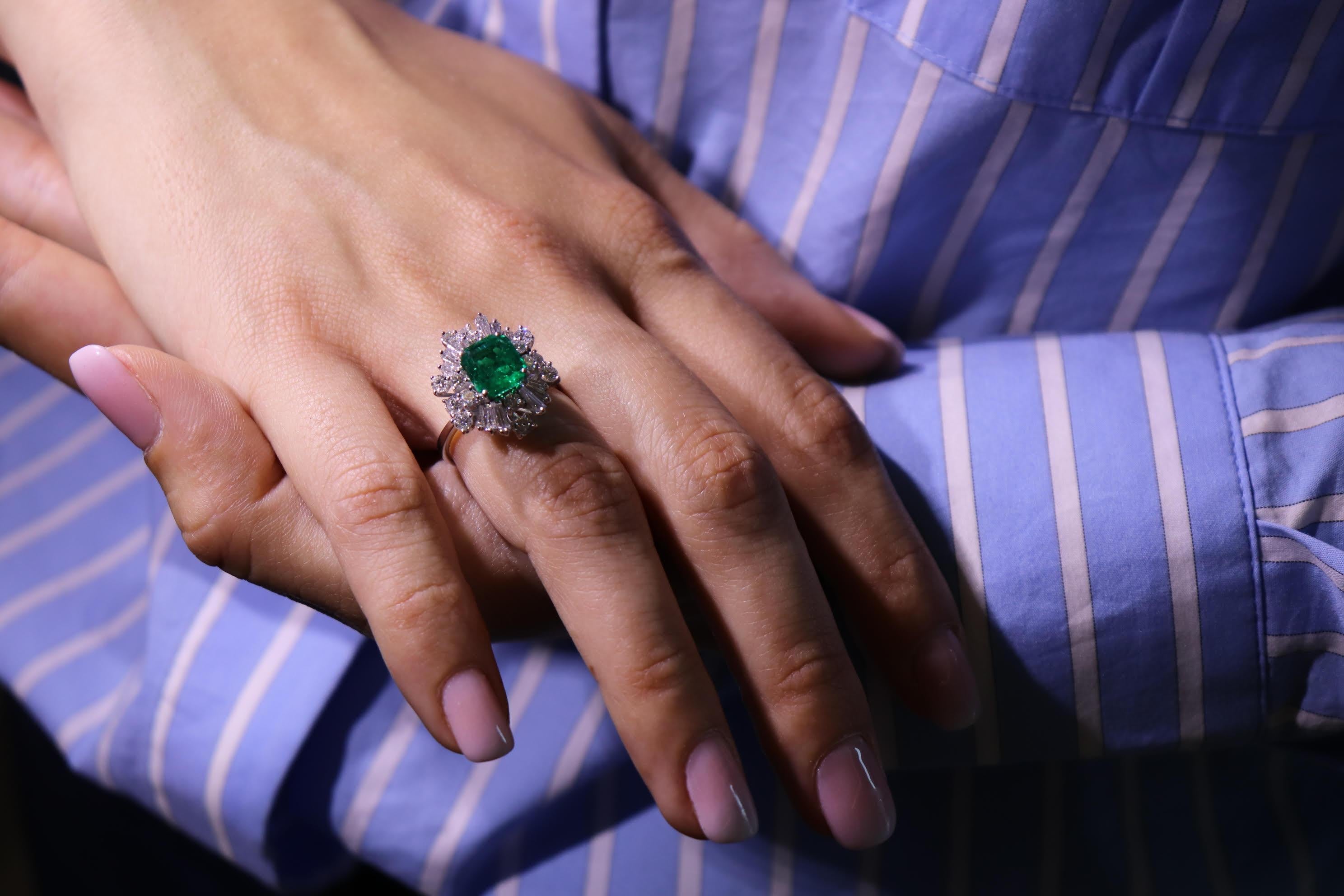 This 18K white gold stunning ring is from our Timeless Collection. It is made of a beautiful emerald cut emerald 2.09 Carat decorated by natural colorless tapered and round brilliant shape diamonds in total of 1.47 Carat. Total metal weight is 5.18