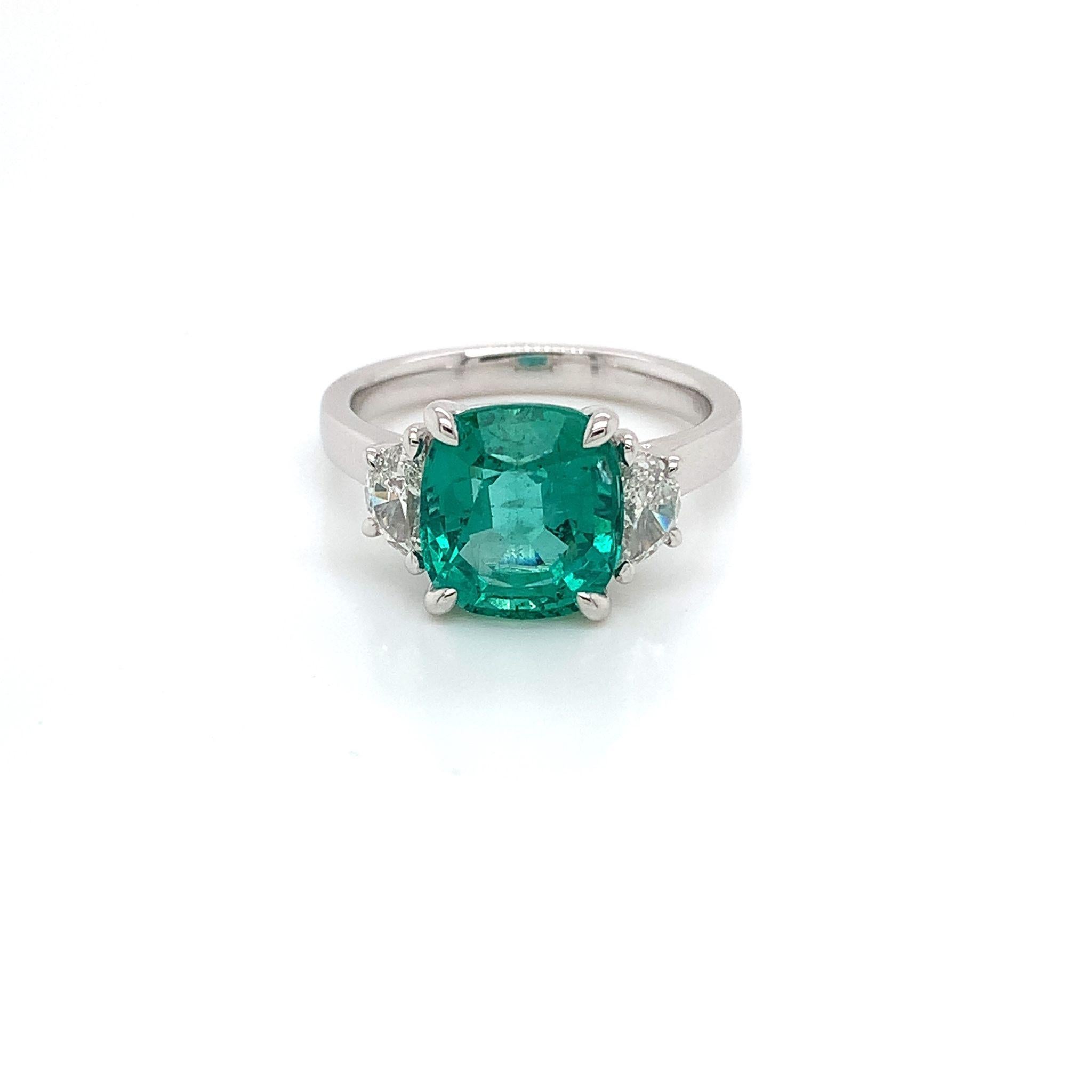 Certified 3.44 ct cushion Emerald
Measuring (9.8x8.9) mm
One Pair of half moon diamonds weighing .48 cts
Diamonds measuring (5.5x3.0) mm
Set in 18K white gold ring
Weighing 5.26 grams