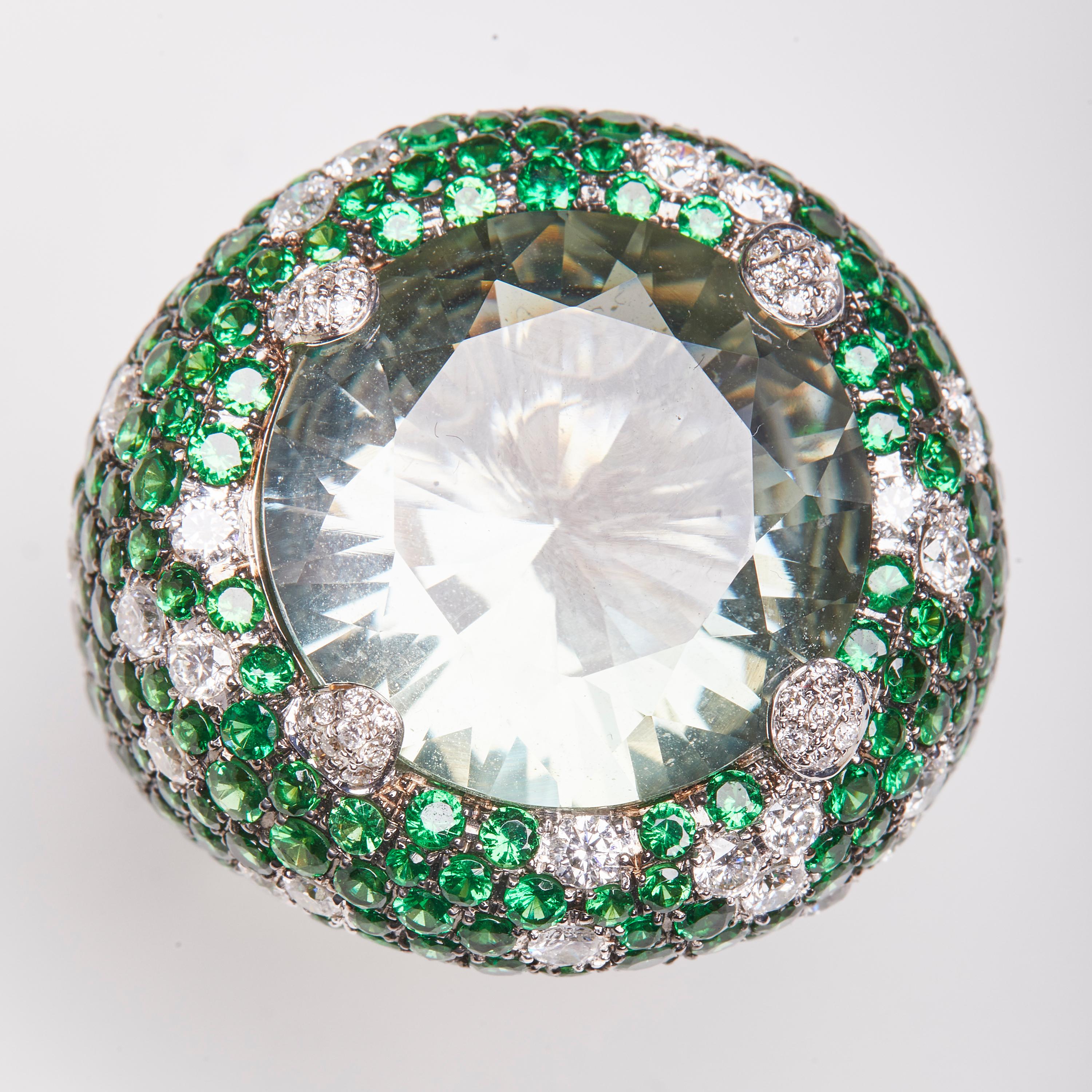 This White gold ring consisting Diamonds and Tsavorite surrounding a Round cut Amethyst center stone
The Vivid green is inspired by the Italian culture where the color is the definition Hope while green Amethyst is to many people a symbol of the