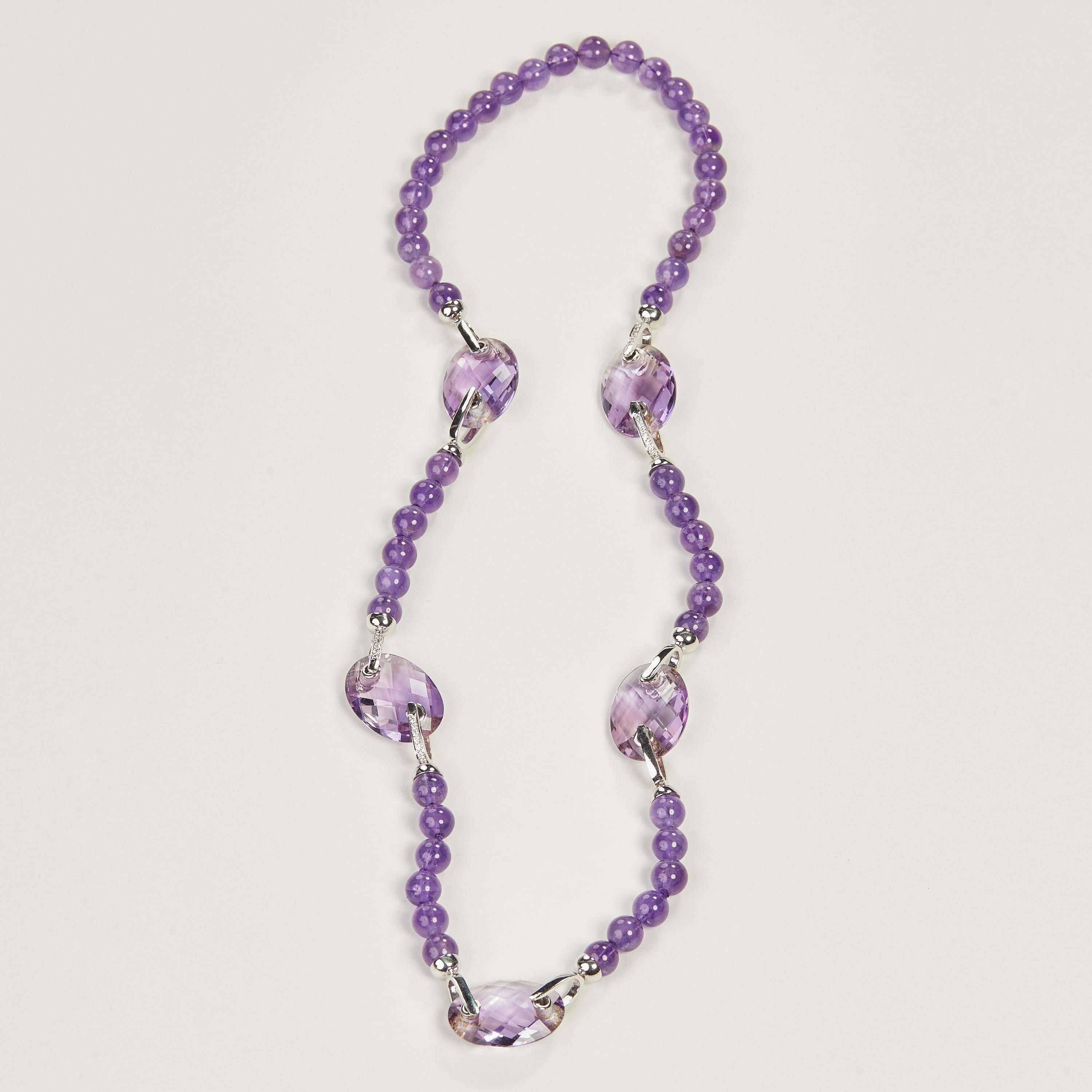 18 Karat White Gold Diamond and Amethyst Necklace
70 Diamonds 0.84 Carat
5 Amethyst Oval  99,53 Carat
48 Amethyst balls 57,04 Carat

Founded in 1974, Gianni Lazzaro is a family-owned jewelery company based out of Düsseldorf, Germany.
Although rooted