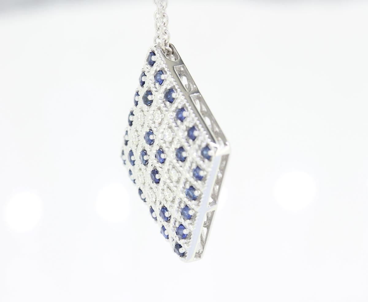 A Beautiful Handcrafted Necklace in 18 Karat White Gold with Natural & Ethically Mined  Diamond and Blue Sapphire in a Double Halo Diamond Necklace with 18