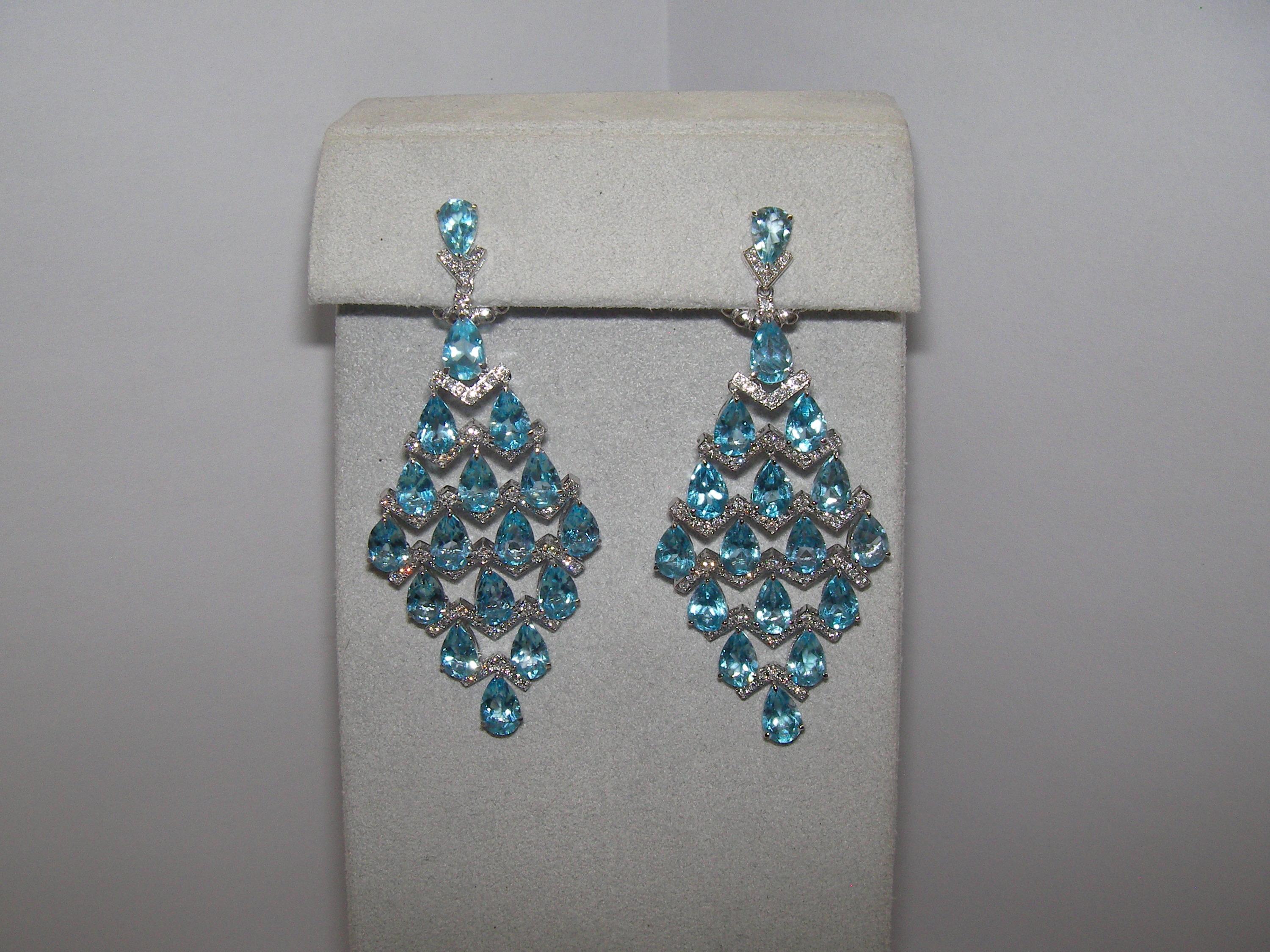 A dazzling pair of 18 Karat White Gold Dangle Earrings encrusted with Diamonds accenting each vivid Blue Topaz stone. 

34 Blue Topaz 17.36 Carats 
168 Diamonds 0.78 Carats


Founded in 1974, Gianni Lazzaro is a family-owned jewelery company based