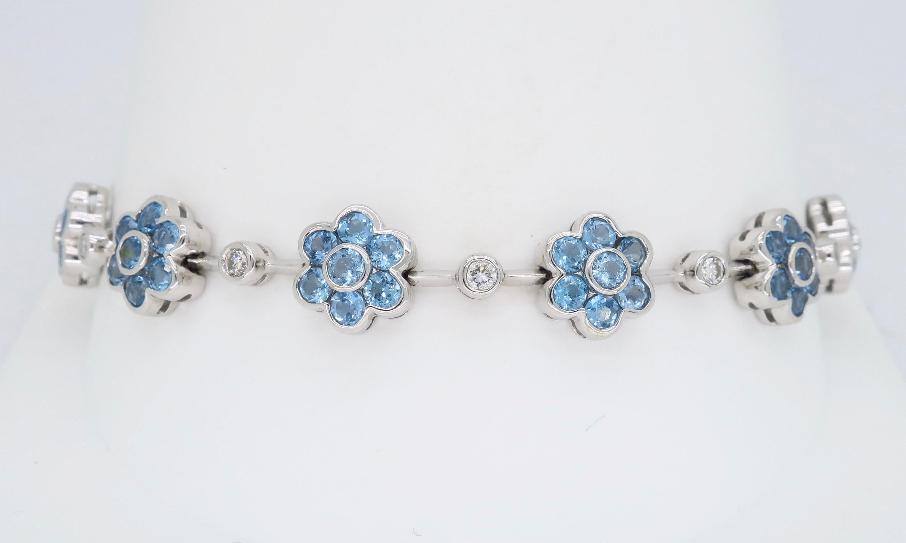 Beautiful floral designed bracelet featuring blue topaz and diamonds set in 18k white gold.

Gemstone: Blue Topaz & Diamond
Gemstone Carat Weight: 77 Round Cut Topaz 2.5mm each
Diamond Cut: 11 Round Brilliant Cut Diamonds
Average Diamond Color: