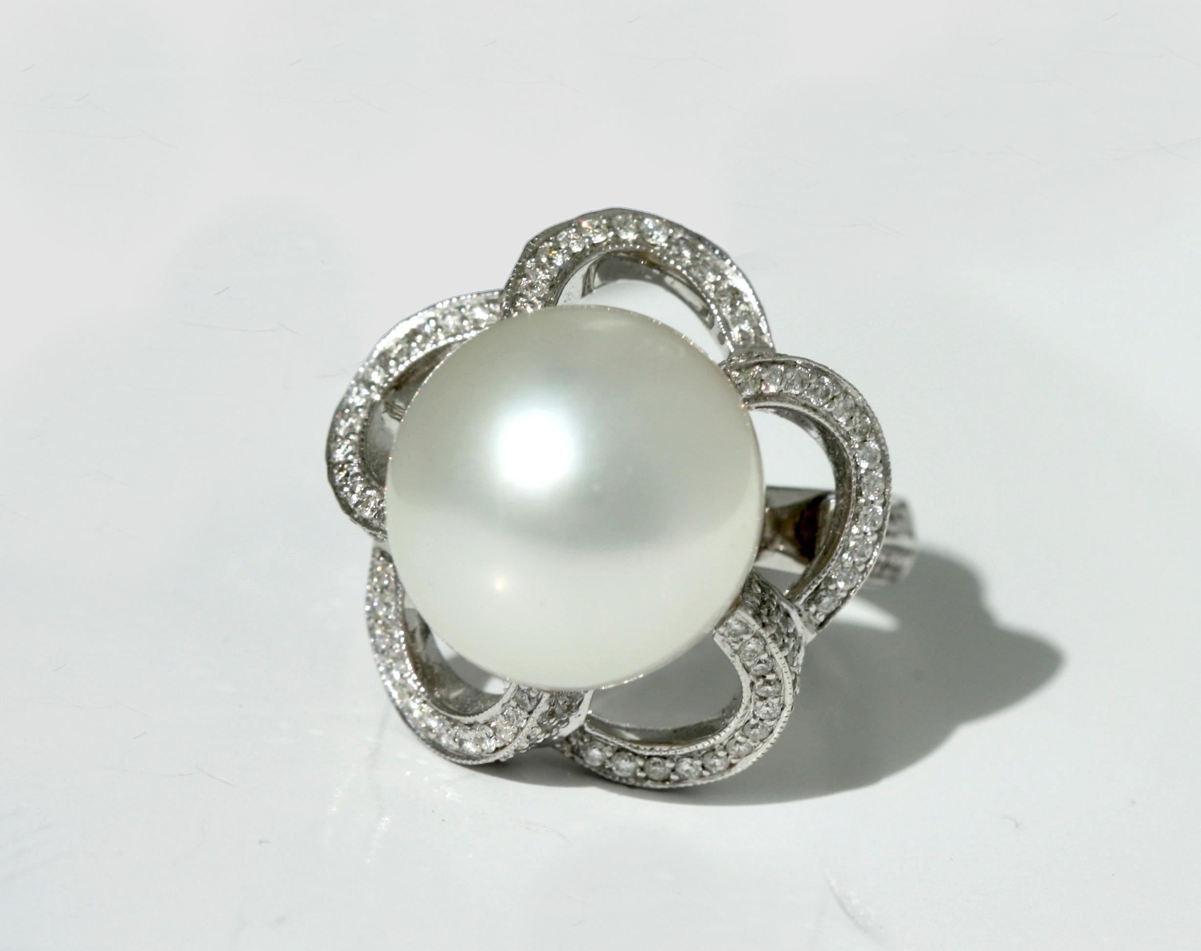 18 Karat White Gold, Diamond and Cultured Pearl Ring
Centered by a pearl measuring approximately 13.6 by 13.9 mm 
accented by round diamonds weighing approximately 1.0 carats, size 6.

