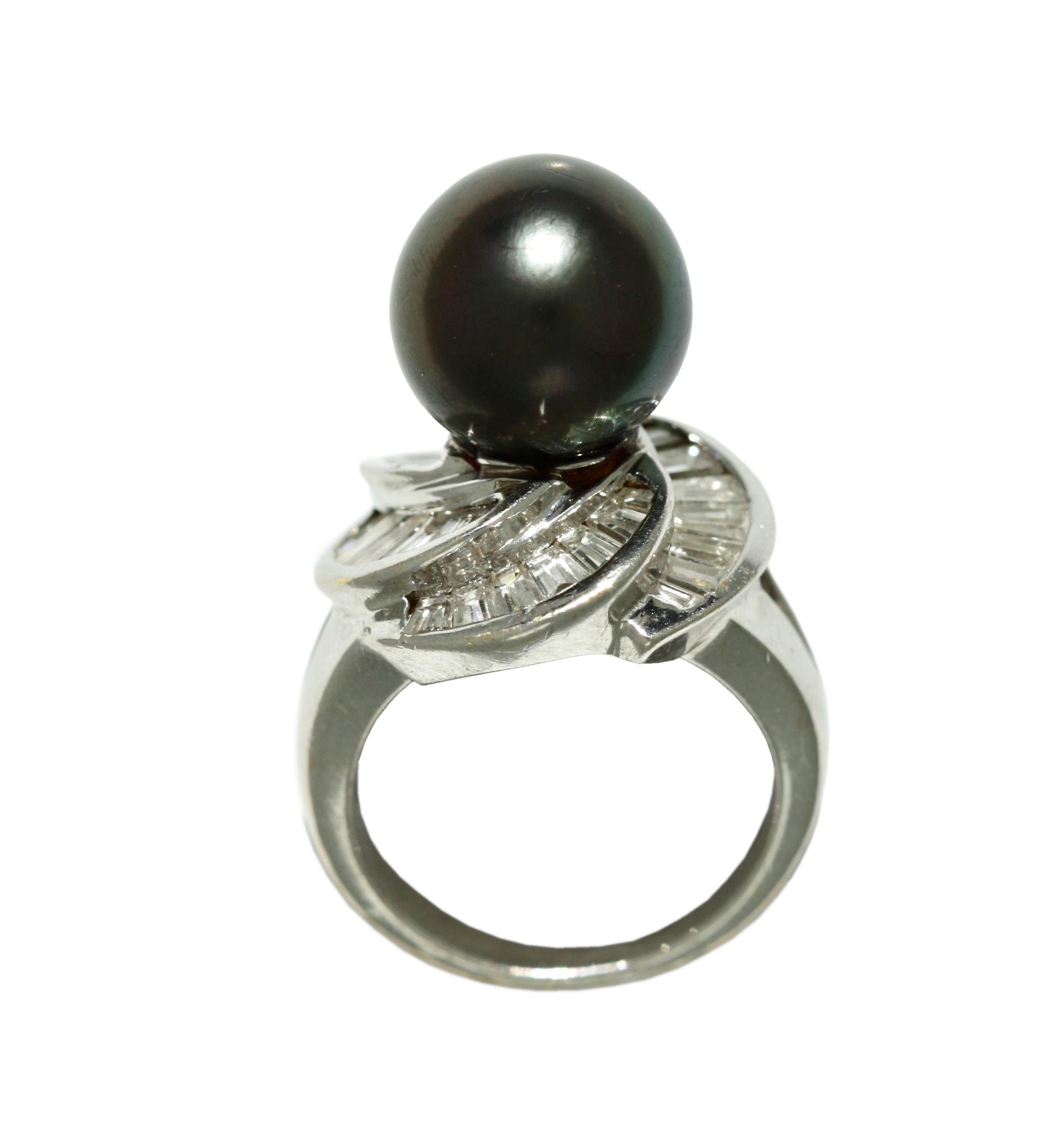 18 Karat White Gold, Diamond and Cultured Pearl Ring
Centered by a Tahitian Pearl measuring approximately 11.7 by 11.6 mm 
diamonds weighing approximately 3.08 carats, size 4 3/4