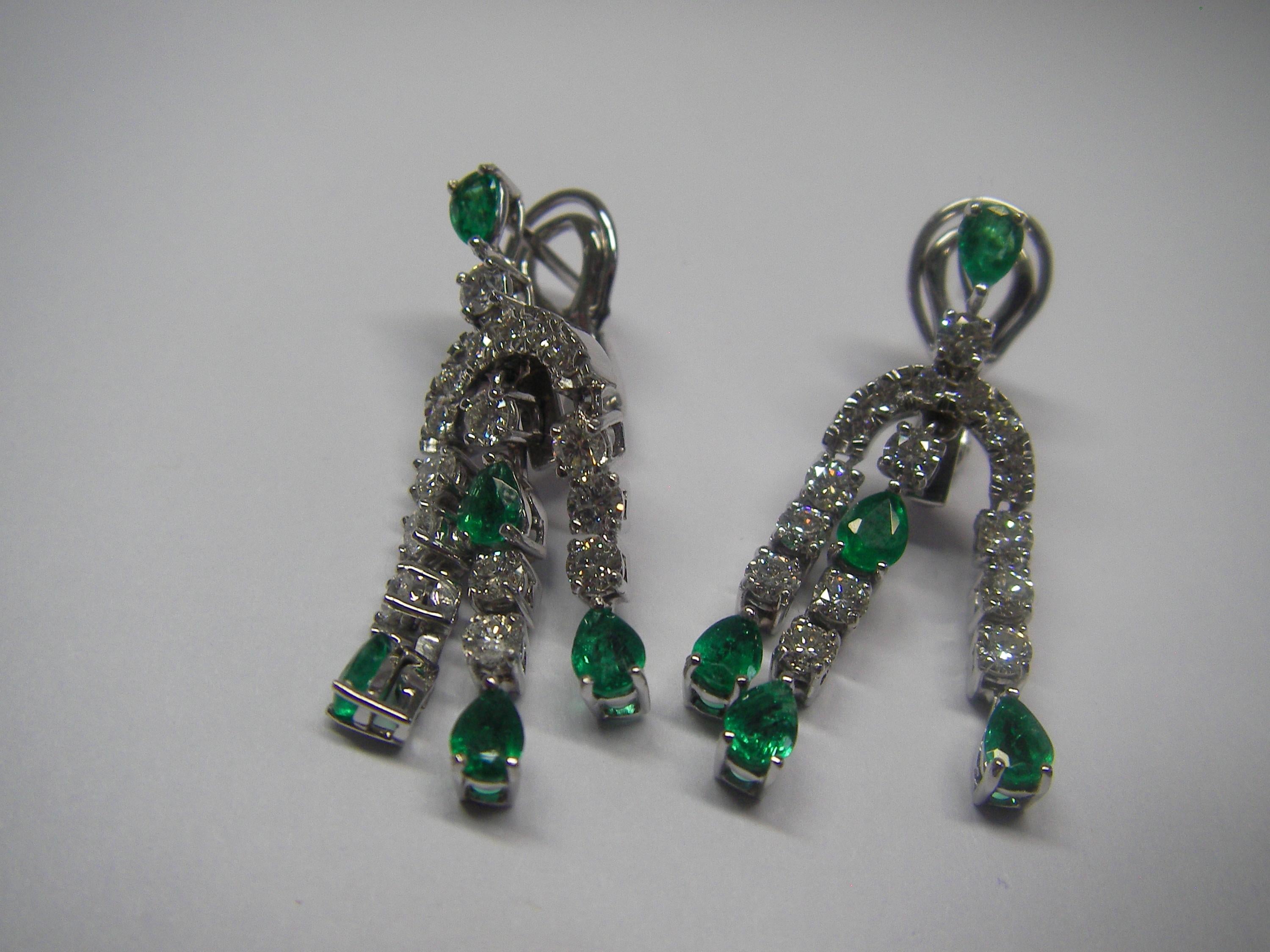 Oval Cut 18 Karat White Gold Diamond and Emerald Dangle Earrings
