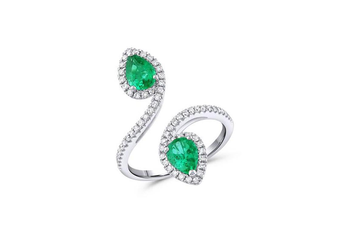 18kt white gold diamond and emerald ring with double pear design. 2 pear shape emeralds = 1.14ctw. 66 pave diamonds = 0.38ctw G-H color VS2-SI1 clarity.