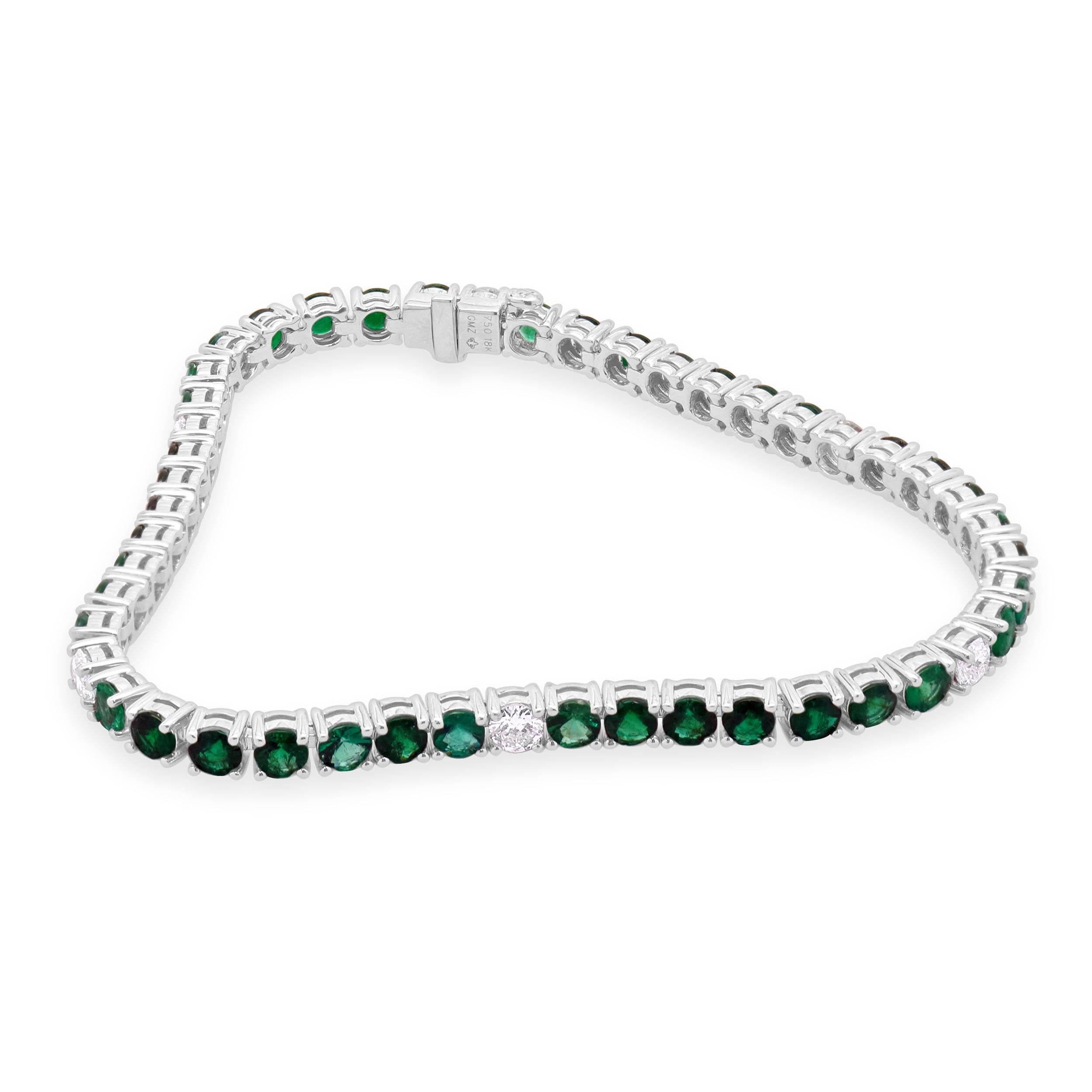 Designer: custom
Material: 14K white gold
Diamond: round brilliant cut= 0.95cttw
Color: G
Clarity: VS-SI1
Emerald: round cut = 5.38cttw
Weight: 12.84 grams
Dimensions: bracelet will fit up to a 7.5-inch wrist
