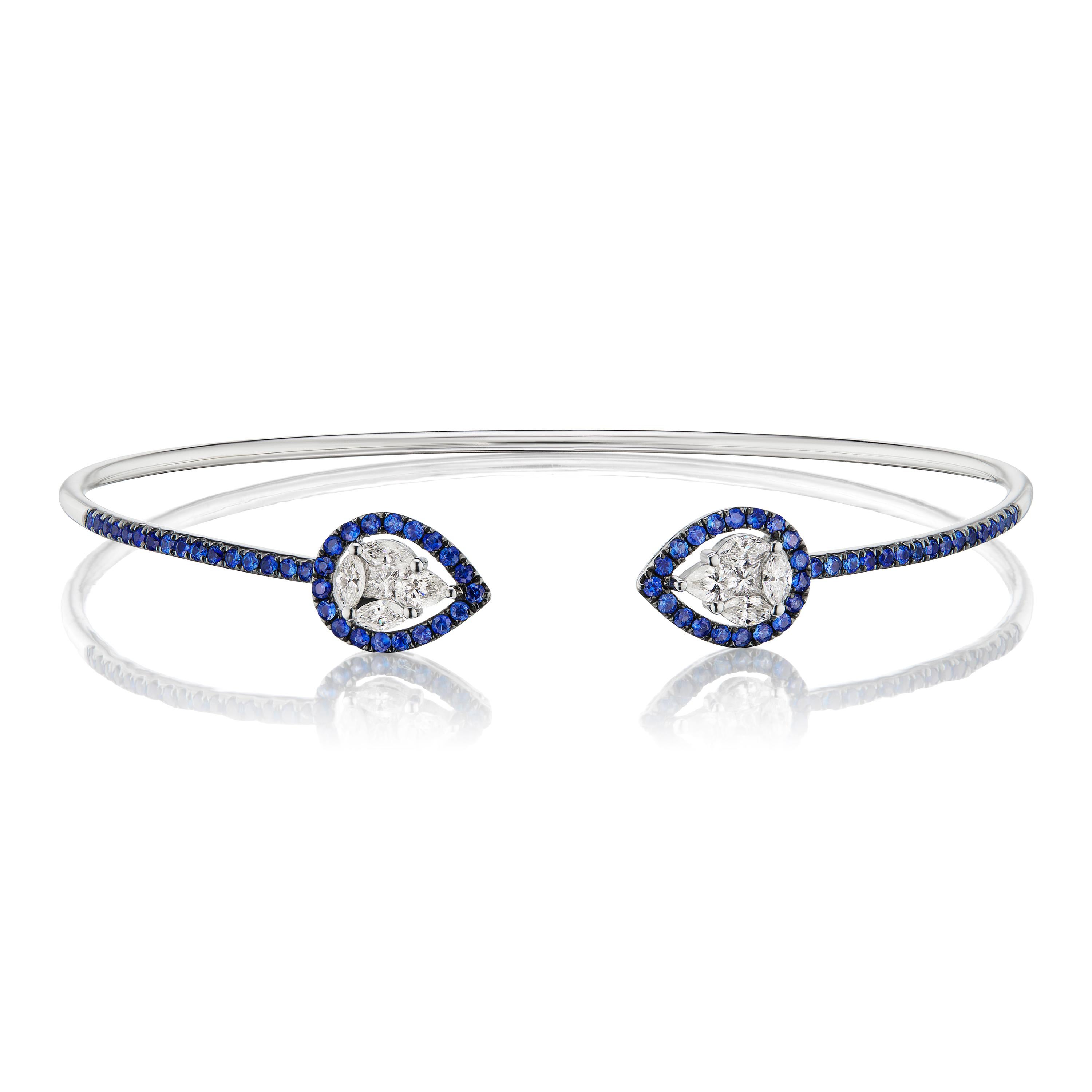 Enchanting blue sapphires and diamonds come together to make this beautiful cuff bangle. Each bangle consists of 10 diamonds of varied shapes and sizes framed within 70 blue sapphires in pave. 

JEWELRY SPECIFICATION :
Approx Metal Weight: 4.79