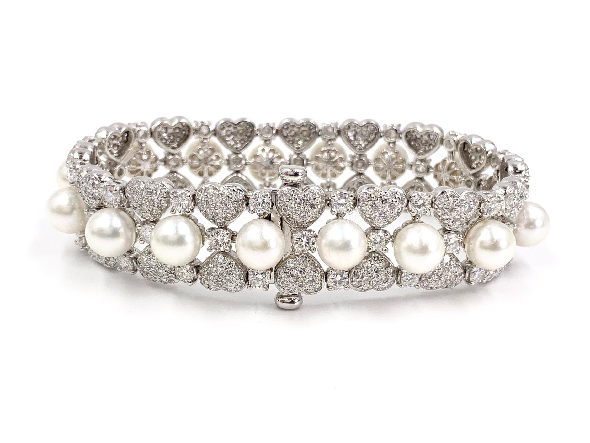 A stunning (and comfortable!) 18 karat white gold white round brilliant diamond and white lustrous pearl 16mm wide bracelet. 11.67 carats of diamonds have an approximate quality of G color, VS2 clarity at 11.67 carats total weight. 7mm well rounded