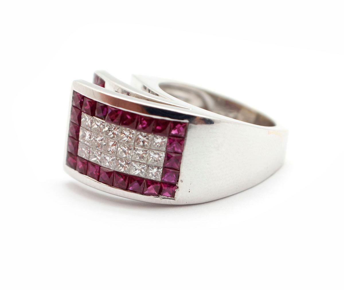 This fabulously modern band is designed in 18k white gold. The ring features invisible-set, princess-cut diamonds and square-cut rubies. The diamonds have a total weight of 0.90ct, and they are graded G-H in color and VS in clarity. The rubies have
