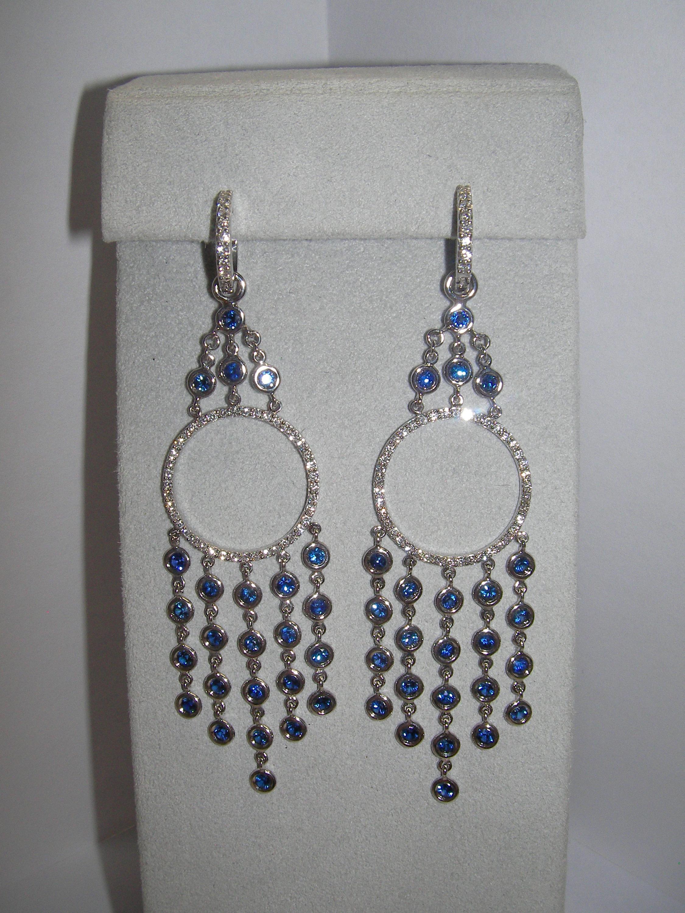 These 18 Karat White Gold Dangle Earrings combine the perfect elements of a retro, yet contemporary design. Each piece holds a variety of vivid Sapphire stones and round Diamonds. This set is the missing piece for your next beautiful evening