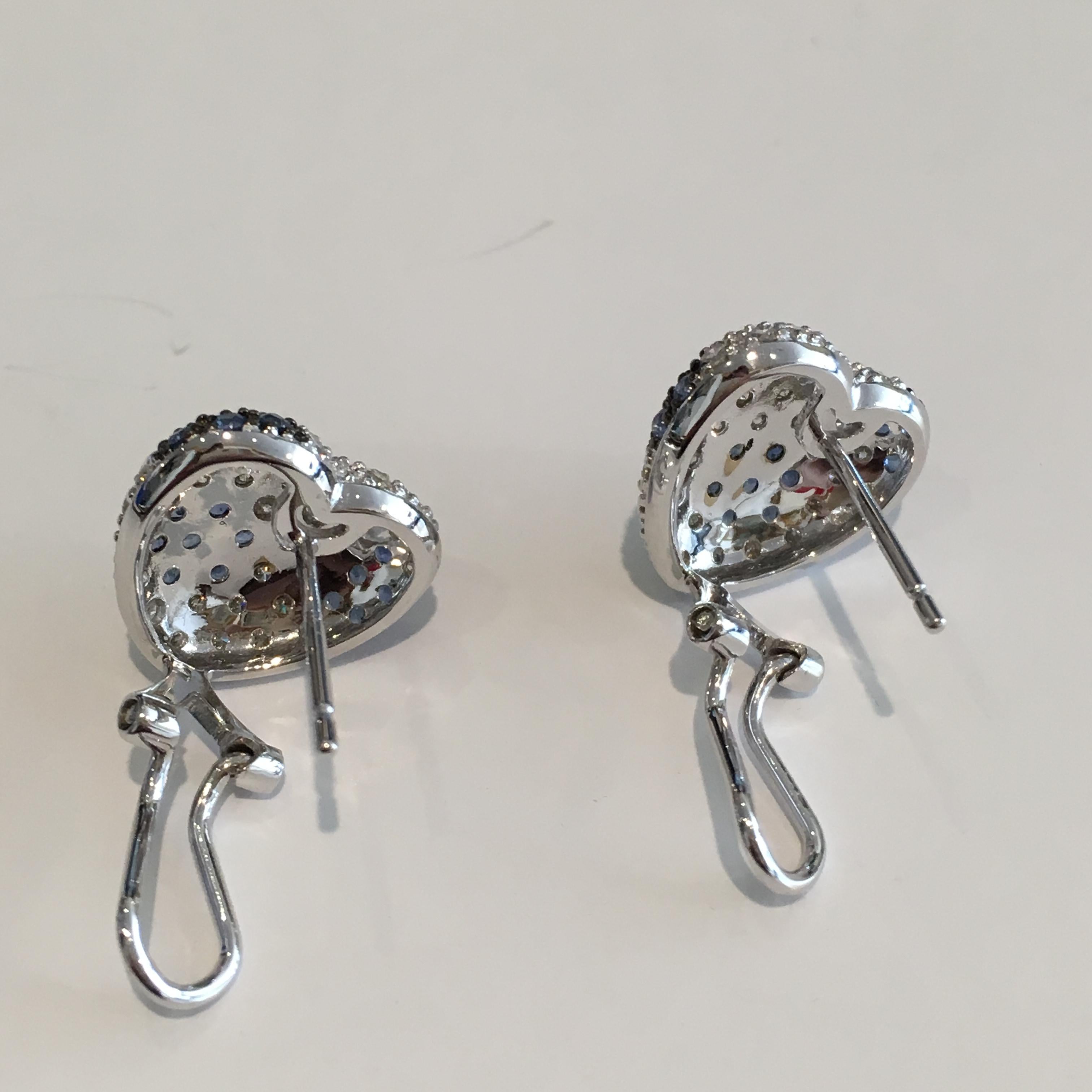 Ladies heart shaped earrings with diamond and sapphires set in 18k white gold.

Stamped 18k, 750 and weigh 6.2 grams.

The diamonds are round brilliant cuts, 1.80 total carats, i color, vs clarity.

The natural blue sapphires are a medium blue color