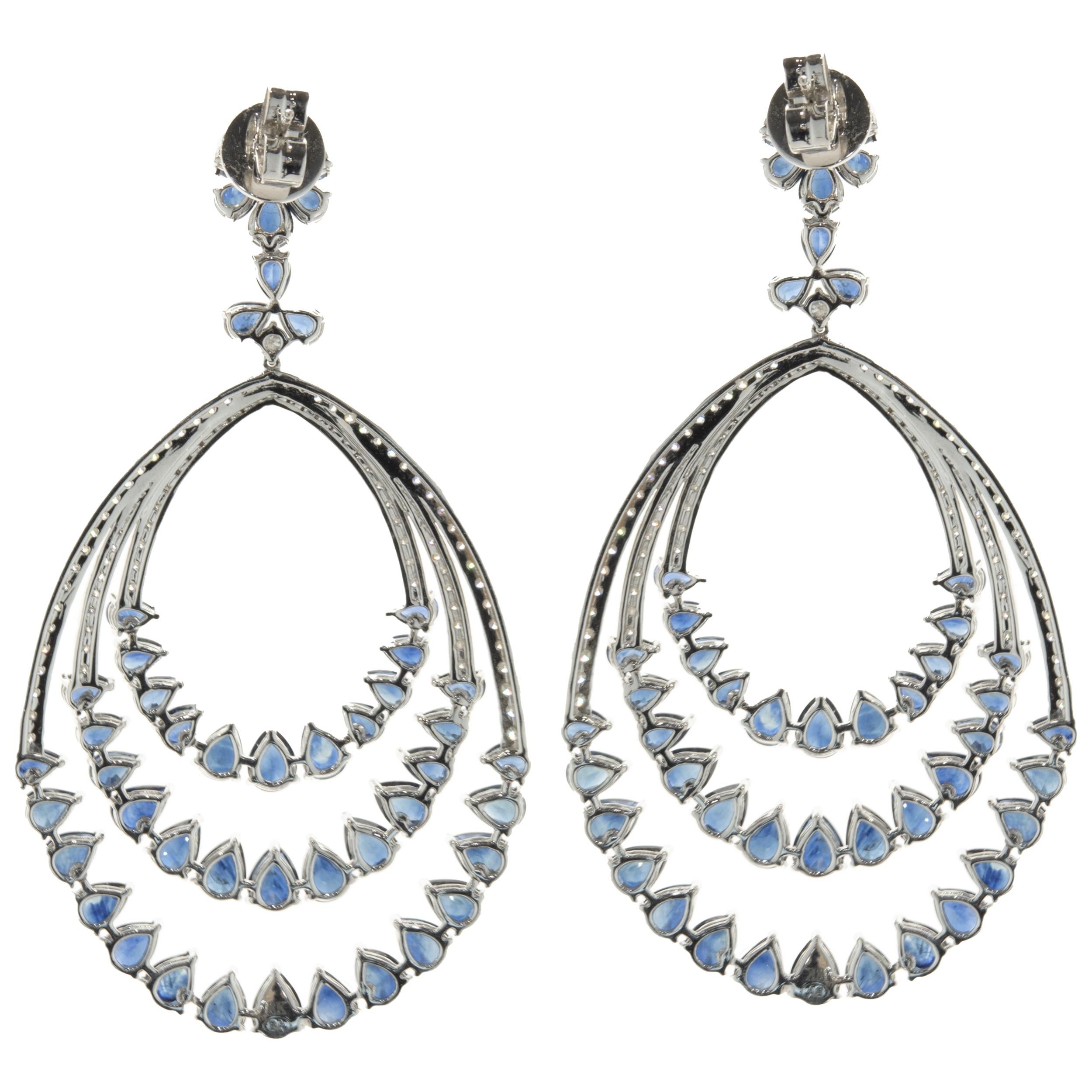 Designer: custom
Material: 18K white gold
Diamonds: round brilliant cut = 2.09cttw
Color: G
Clarity: SI1
Sapphire: 96 pear cut = 26.79cttw
Color: Blue
Clarity: AAA
Dimensions: earrings measure 2.75-inches in length
Fastenings: posts with omega