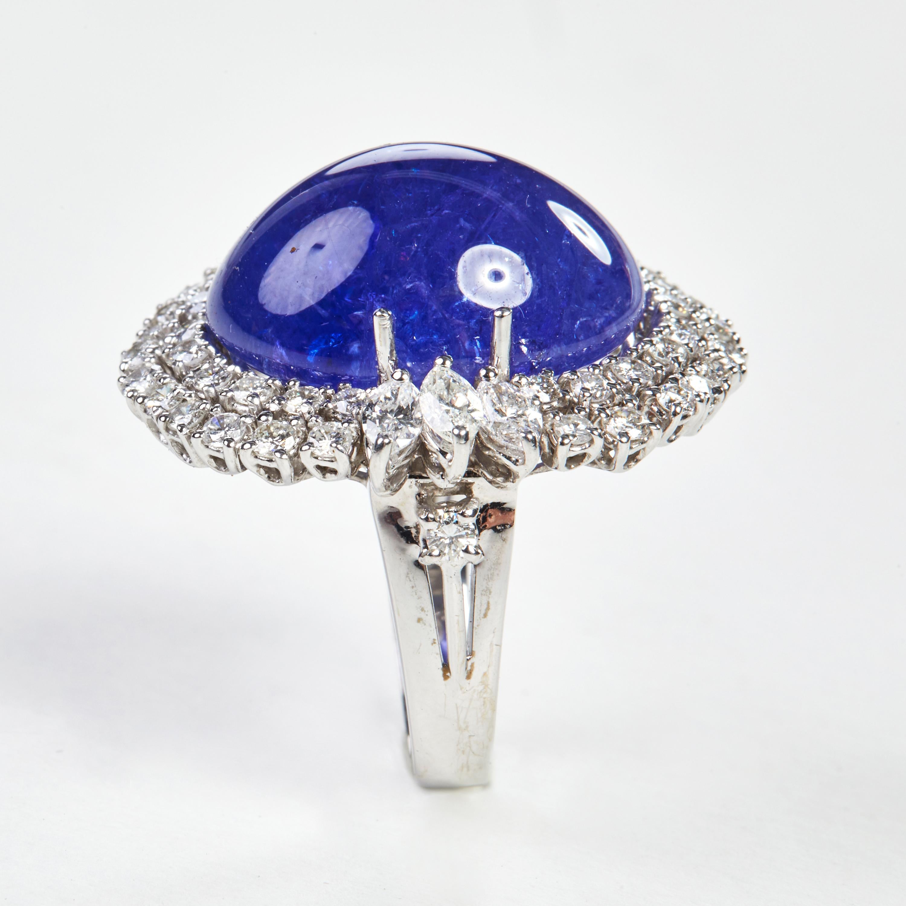 
Beautiful 18 Karat white gold cocktail ring with a stunning 26.27 carat tanzanite center stone. This ring combines classical with modern elements and can be worn every day! 

46  Diamonds 1.27 carat
6 Diamant marq. 0.88 carat
1 Tansanite cab. 26.27