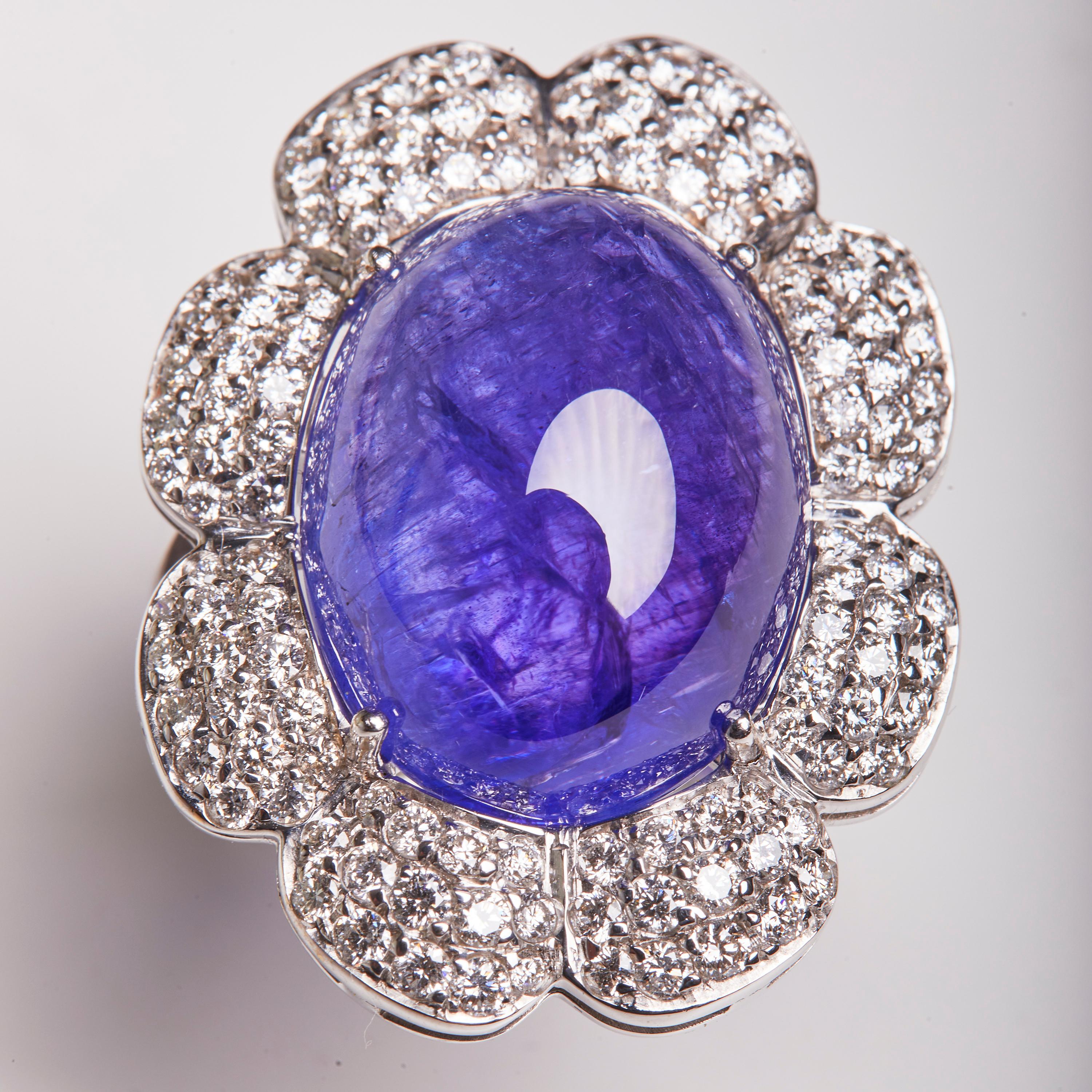 This 18 Karat White Gold Cocktail Ring full of Diamonds highlights a Tanzanite oval shaped center stone. This ring is a perfect compliment to our 18 Karat White Gold Diamond and Tanzanite Earrings and 18 Karat White Gold Diamond and Tanzanite Chain