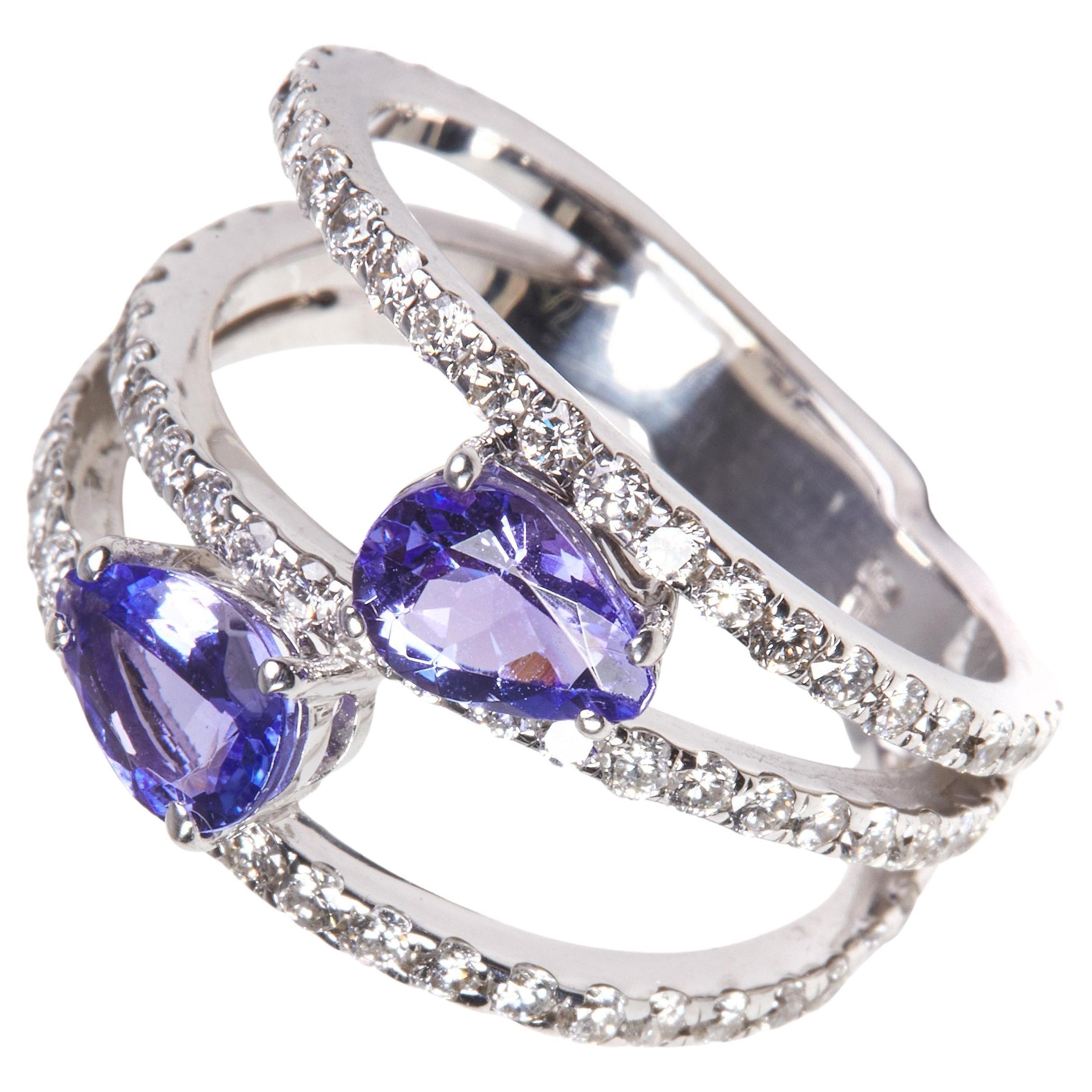 
Beautiful 18 Karat white gold cocktail ring with a stunning 6.50 carat tanzanite center stone. This ring combines classical with modern elements and can be worn every day! 

76  Diamonds 1.11 carat
2 Tanzanite 1.23 carat

Size EU 53.5 US