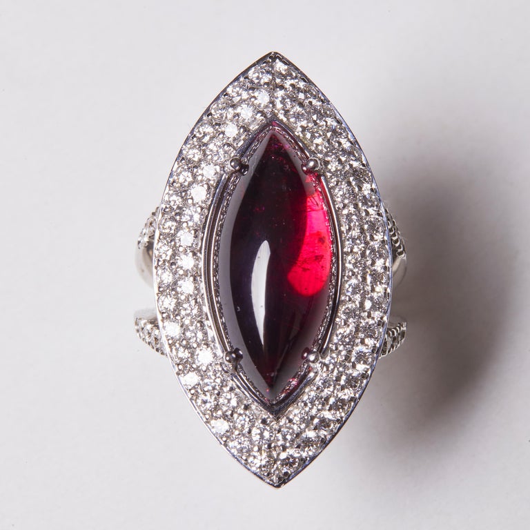 This beautiful 18 Karat White Gold Diamond and Tourmaline Cocktail Ring features a spectacular cabochon cut Tourmaline center stone surrounded by two rows of diamonds. 

86 Diamonds 2.10 Carat HSI
1 Tourmaline Cabochon 10.93 Carat

Size EU 56 US