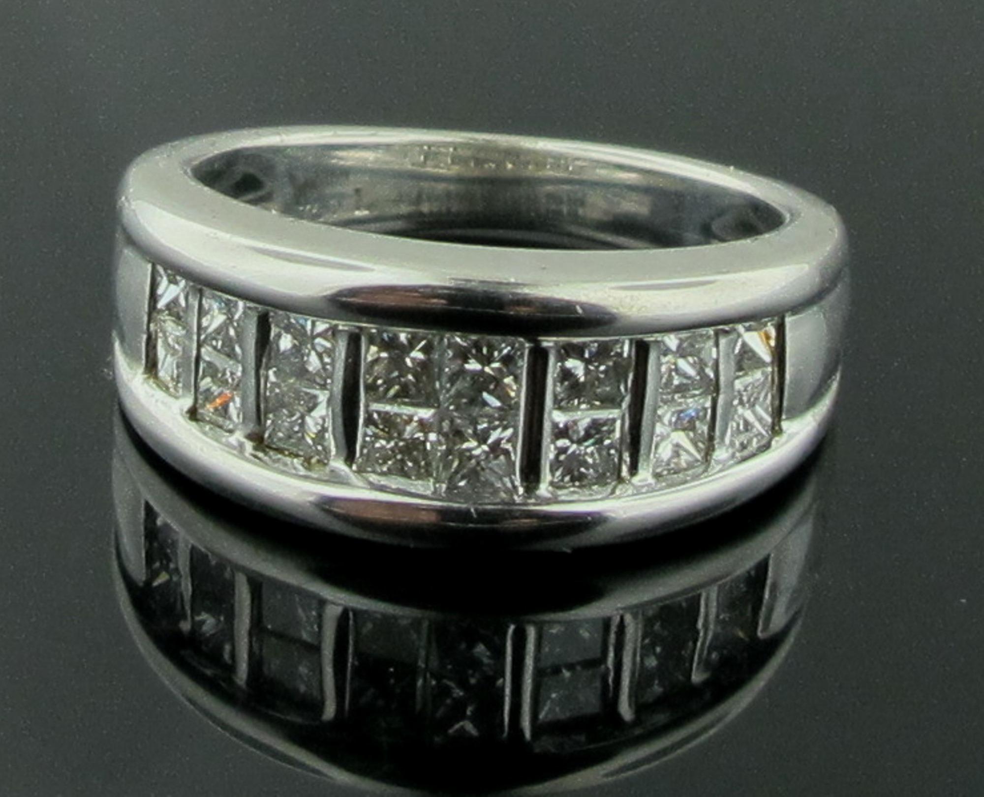 Set in 18 karat white gold are 16 Princess Cut diamonds in 2 rows.  Total diamond weight is 1.00 carats.  Gold weight is 7 grams.  Ring size is 6.25.