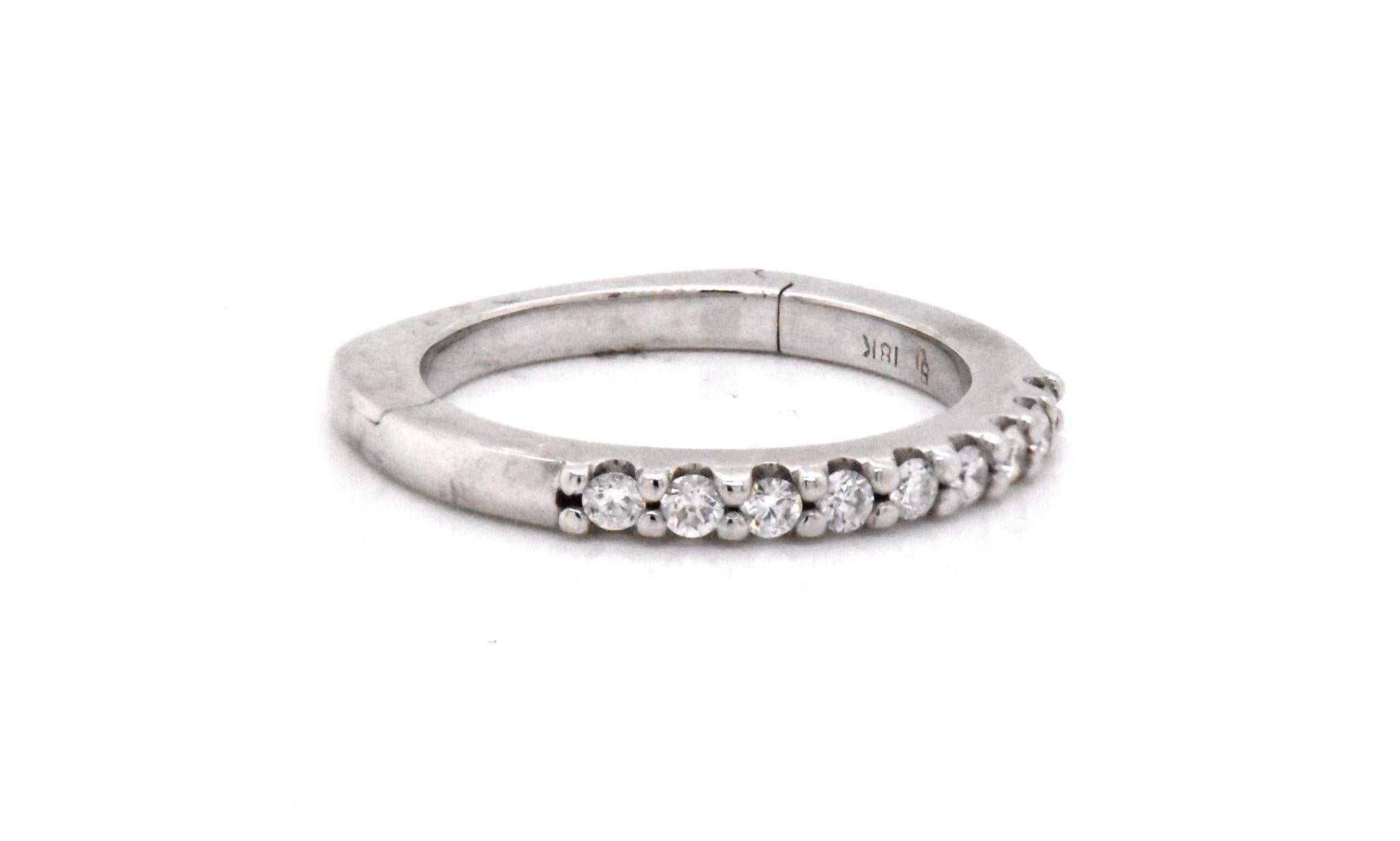 Designer: custom
Material: 18k white gold
Diamonds: 9 round cut = .18cttw
Color: G
Clarity: VS1
Size: 6.5 (please allow two additional shipping days for sizing requests)  
Dimensions: ring measures 2.2mm in width
Weight: 4.39 grams
