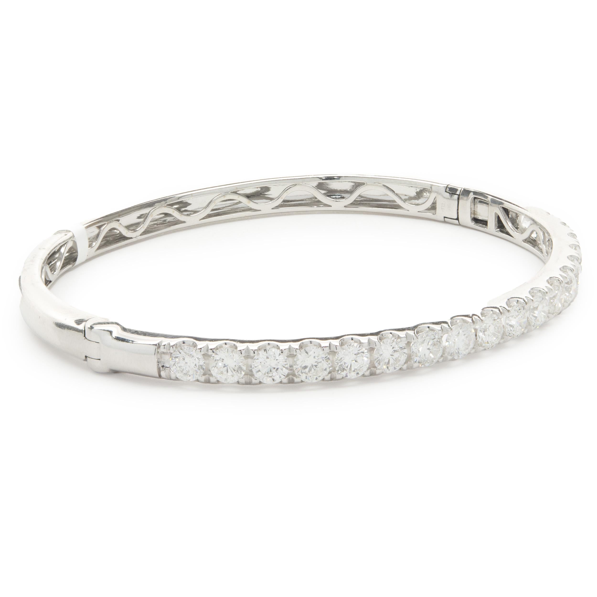 Designer: custom design
Material: 18K white gold
Diamonds: 19 round brilliant cut = 4.00cttw
Color: F
Clarity: VS2
Dimensions: bracelet will fit up to a 7.5-inch wrist
Weight: 15.48 grams