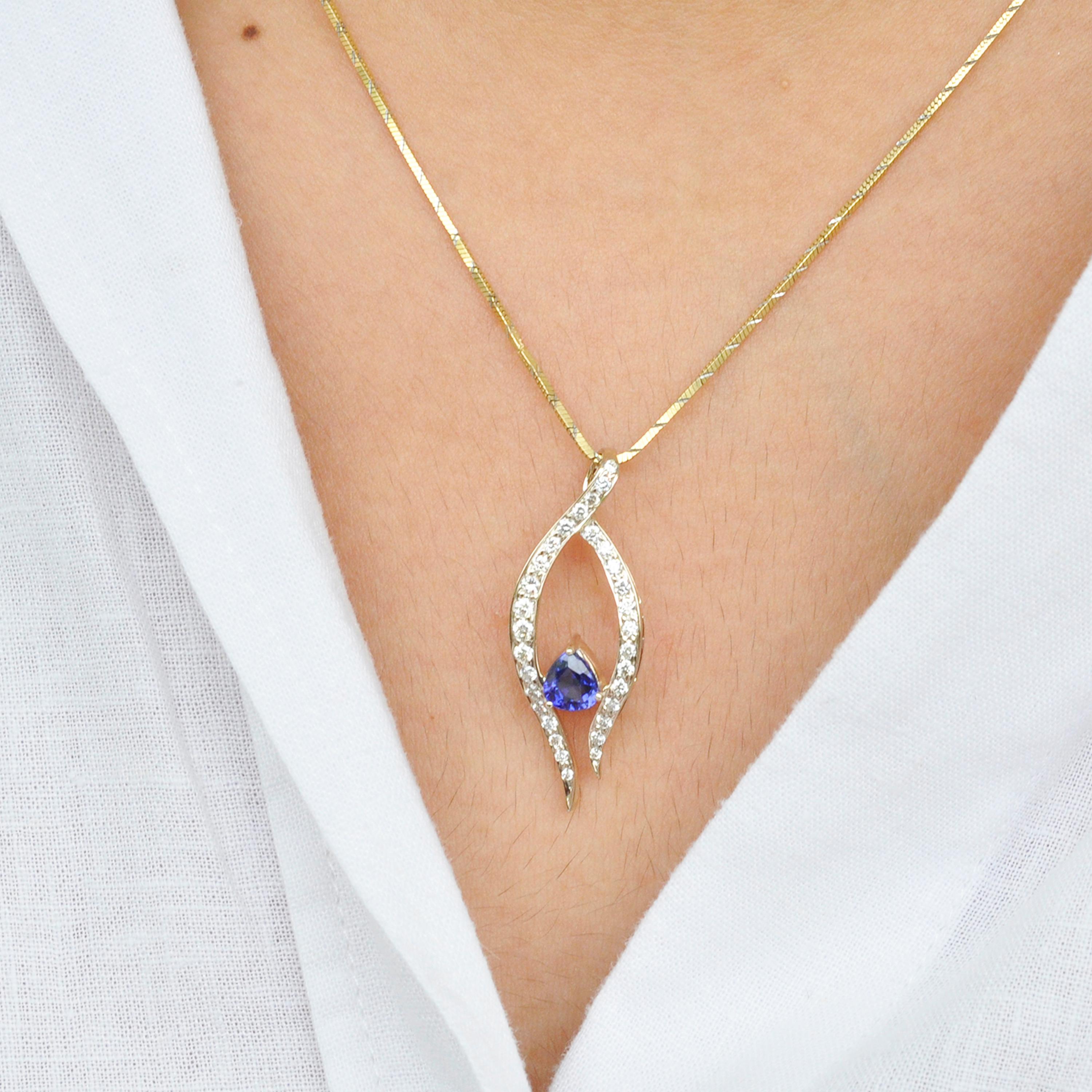 This pendant is inspired by the dance form - ballet. A prominent blue sapphire pear is hugged by two warm strands of pave set diamonds in 18 Karat white gold. The pendant is designed to eulogise the graciousness of this dance form and it's dancers.