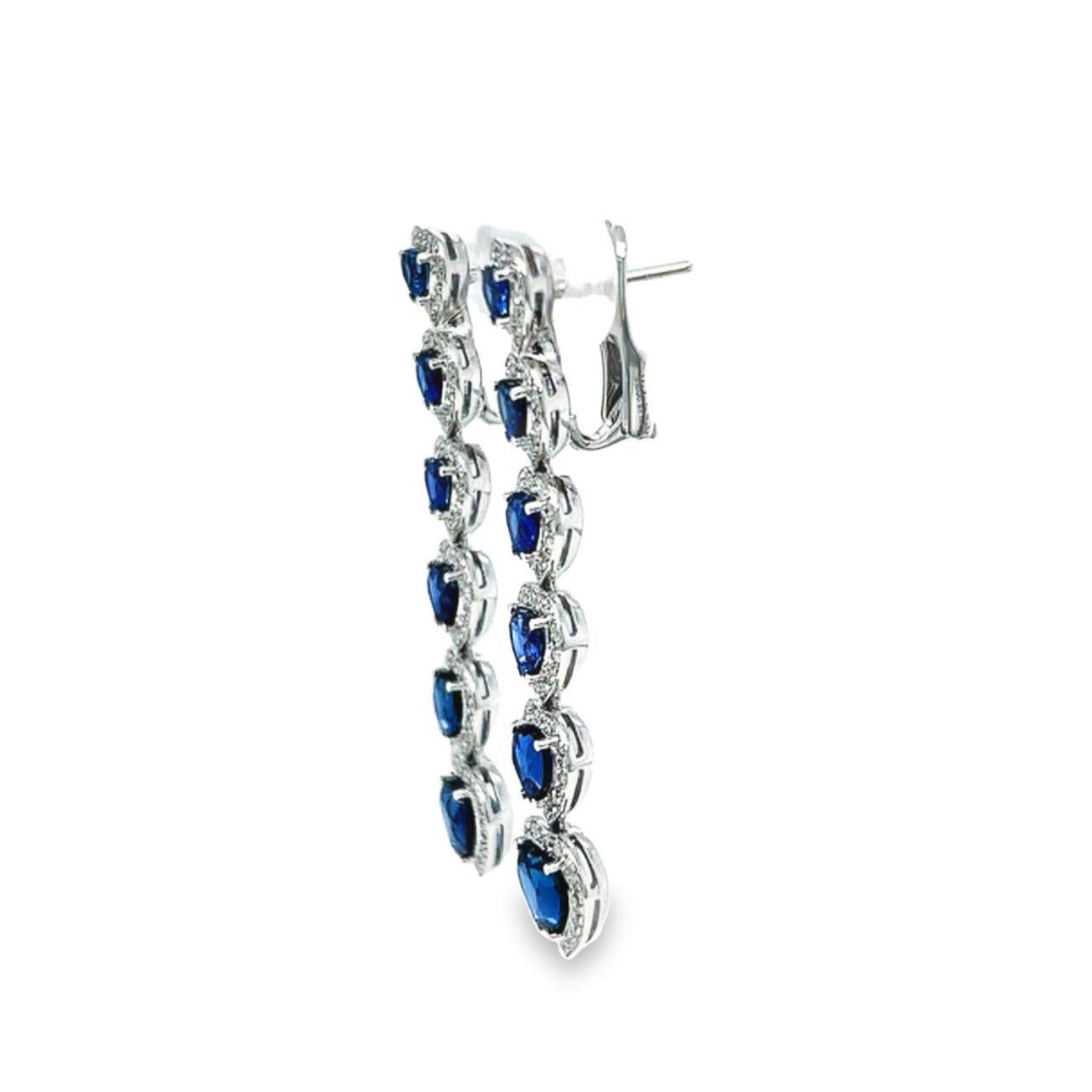 This 18K white gold elegant drop earrings are from our Timeless collection. These stud earrings are made of natural white diamonds in total of 0.60 Carat and natural heart red sapphires in total of 6.55 Carat. Total metal weight is 9 gr. They are