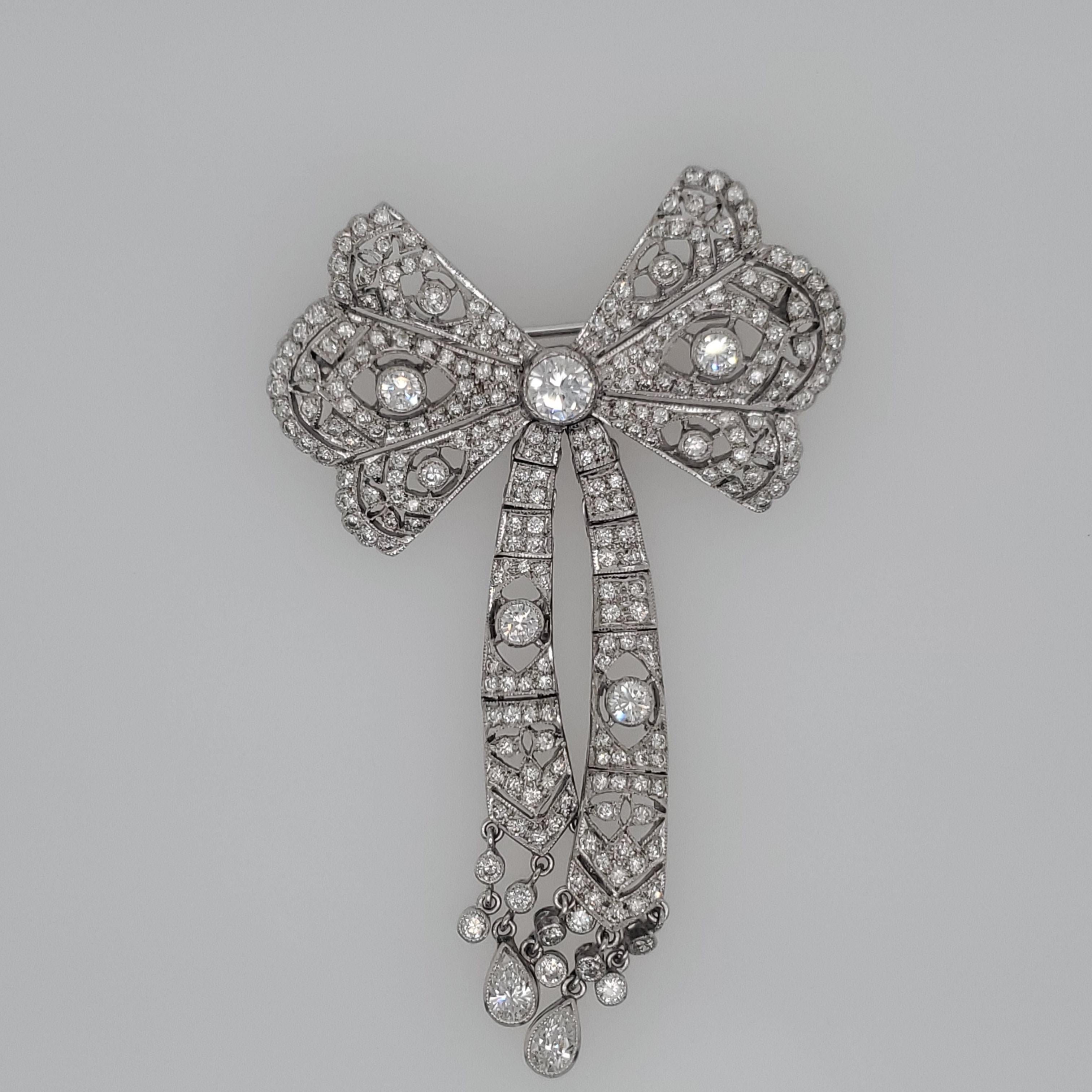 18 Karat White gold Bow Brooch with approximately 2.20 carats of white diamonds.The Pin has movable strands as well as hanging rows of diamonds on the bottom. 