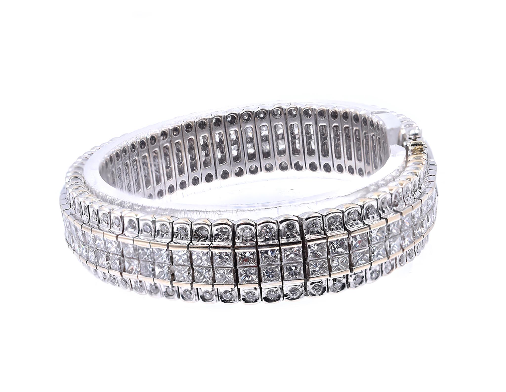 Designer: custom
Material: 18K white gold
Diamonds: 132 round brilliant cut = 1.78cttw
Color: F/G
Clarity: VS1-2
Diamonds: 132 princess cut = 12.08cttw
Color: F/G
Clarity: VS1-2
Dimensions: bracelet will fit up to a 7-inch wrist
Weight: 52.24 grams
