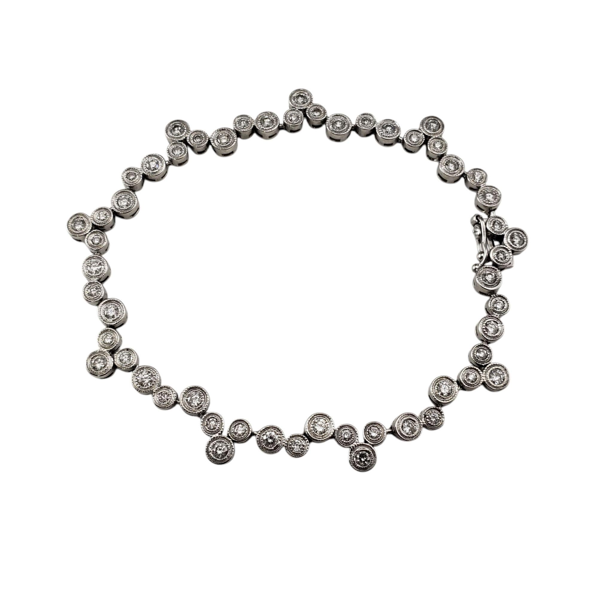 18K White Gold Diamond Circle Design Tennis Bracelet-

Exquisite and timeless, this sparkling bracelet features 54 round brilliant cut diamonds set in 18K white gold, arranged in a refined circle design.

Width: 7 mm.

Approximate total diamond