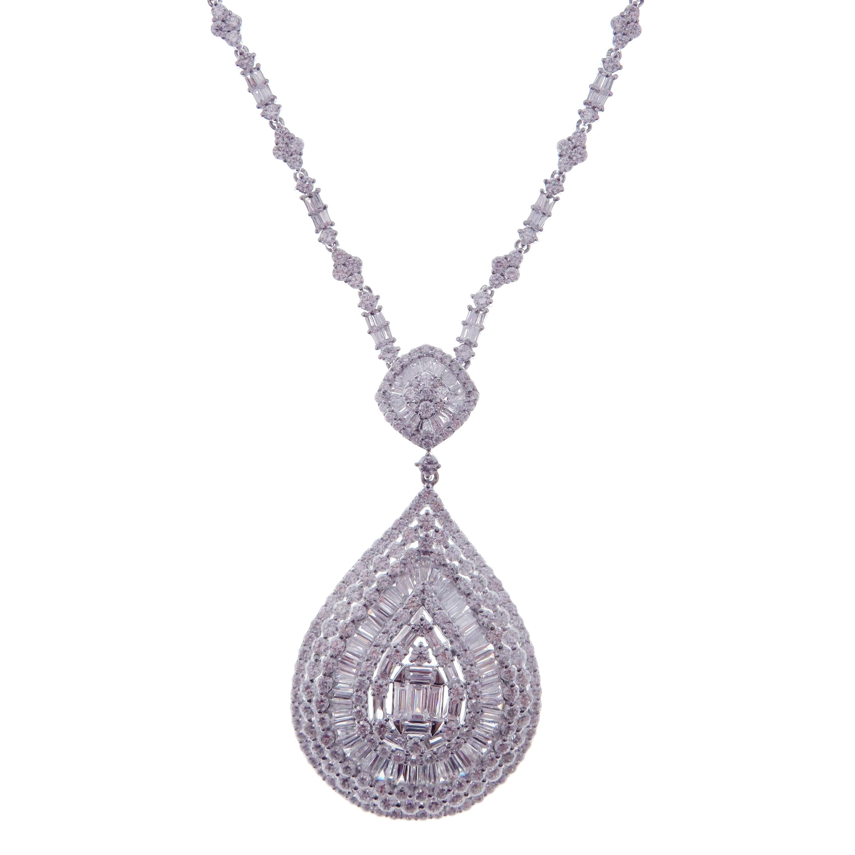 This solid pear baguette necklace is crafted in 18-karat white gold, weighing approximately 11.78 total carats of V Quality white diamond. These are very comfortable, flexible, and lay flat. We have these in matching earrings as well. 

Necklace is