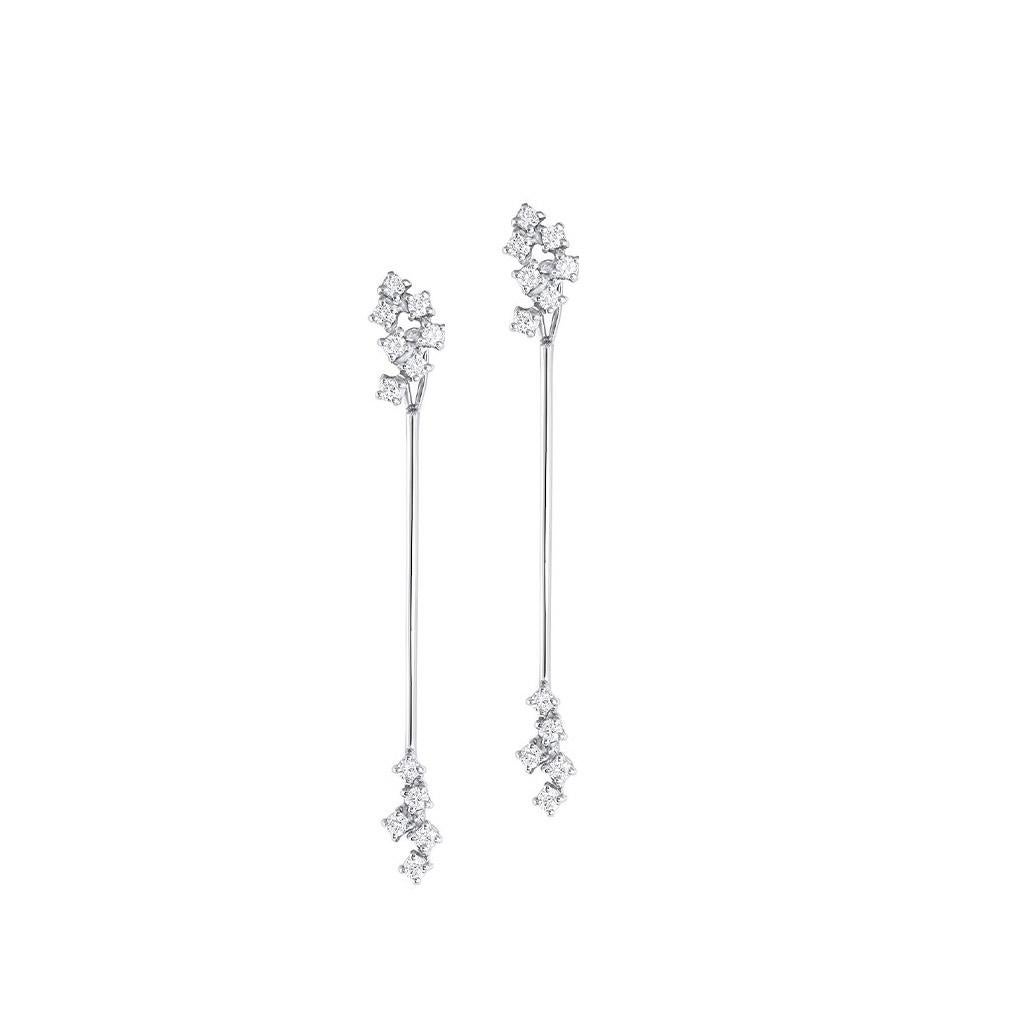 18kt white gold diamond cluster long drop earrings. Diamond clusters elegantly connected by a strand of 18kt white gold. Diamonds are approximately 0.48ctw.