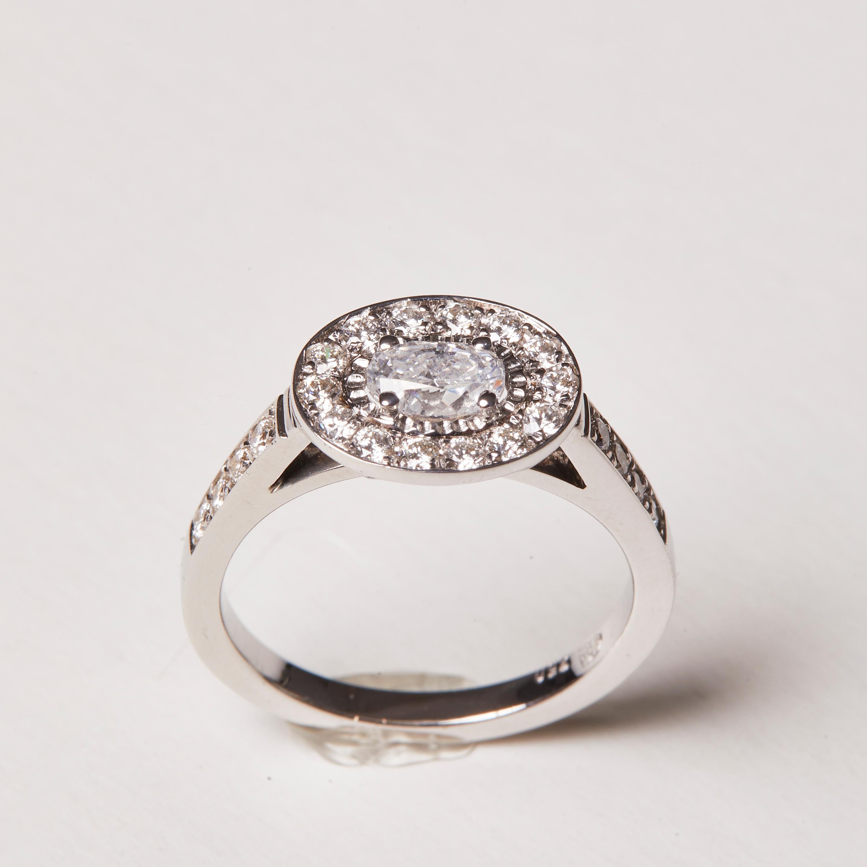 
This 18 Karat white gold cocktail ring will be your next every day go-to-piece! A beautiful oval cut diamond as the mail centerpiece, with a halo of more sparkling diamonds and a pave finish along the ring sides. 

If you like it a bit more