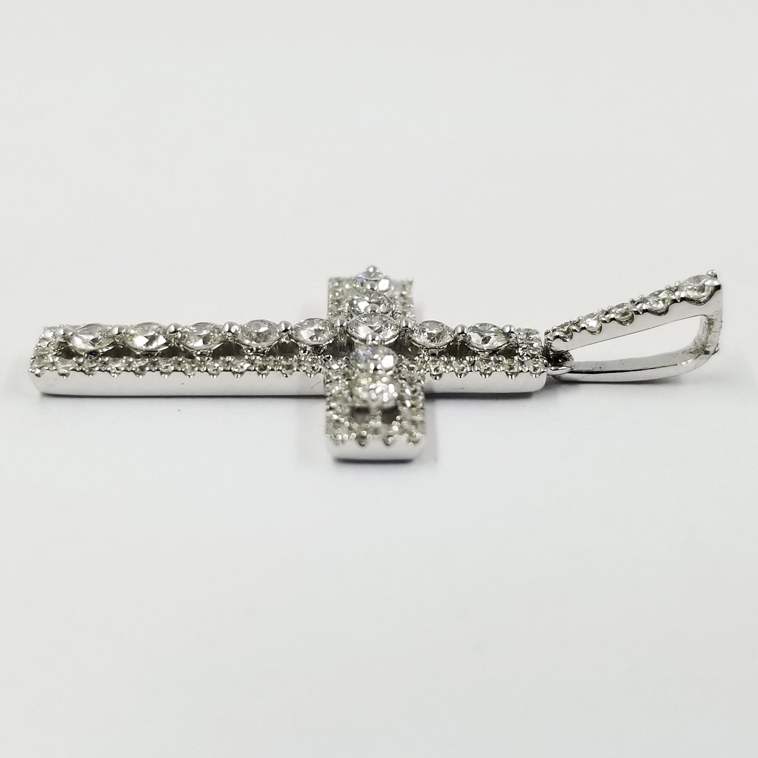 18 Karat White Gold Cross Featuring 83 Round Diamonds Totaling 0.77 Carats of SI Clarity & G Color. The Large Bale Allows for a Variety of Chains To Slide Through.