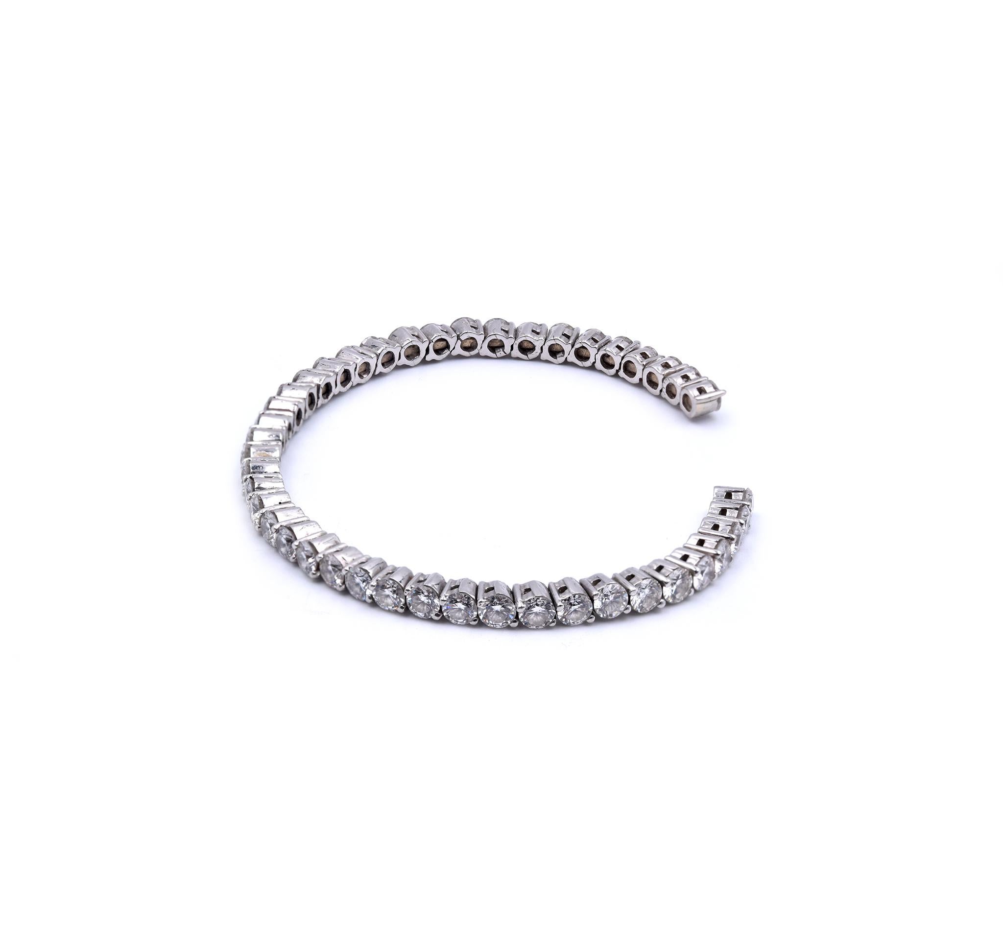 Material: 18K white gold
Diamonds: 42 round brilliant cut = 9.24cttw
Color: G/H
Clarity: VS2-SI1
Dimensions: bracelet will fit up to a 7-7.5-inch wrist
Weight: 26.32 grams
