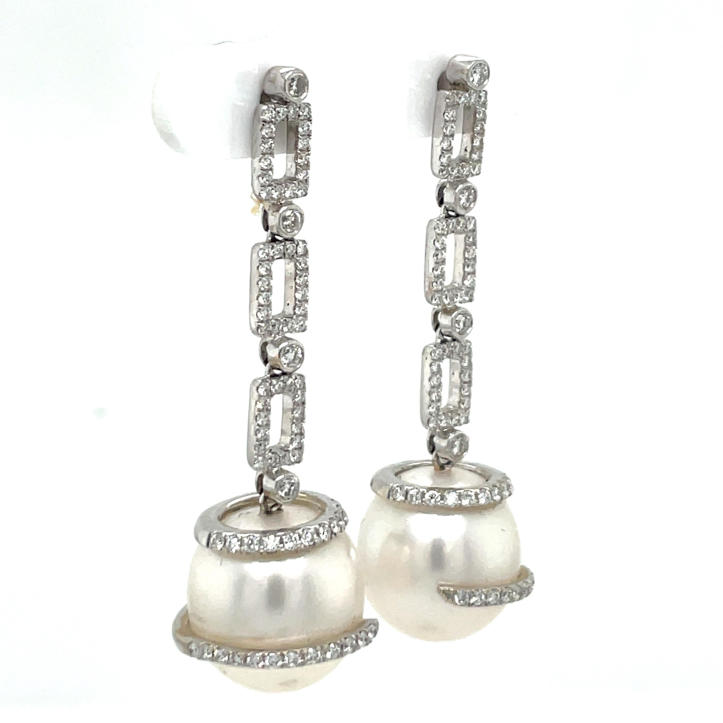 18 Karat White Gold drop earrings featuring 104 round brilliants weighing 1.14 carats and two South Sea Pearls measuring 12-13 MM.
Can customize pearl to Golden, Pink or Tahitian. 
DM for more pricing. 