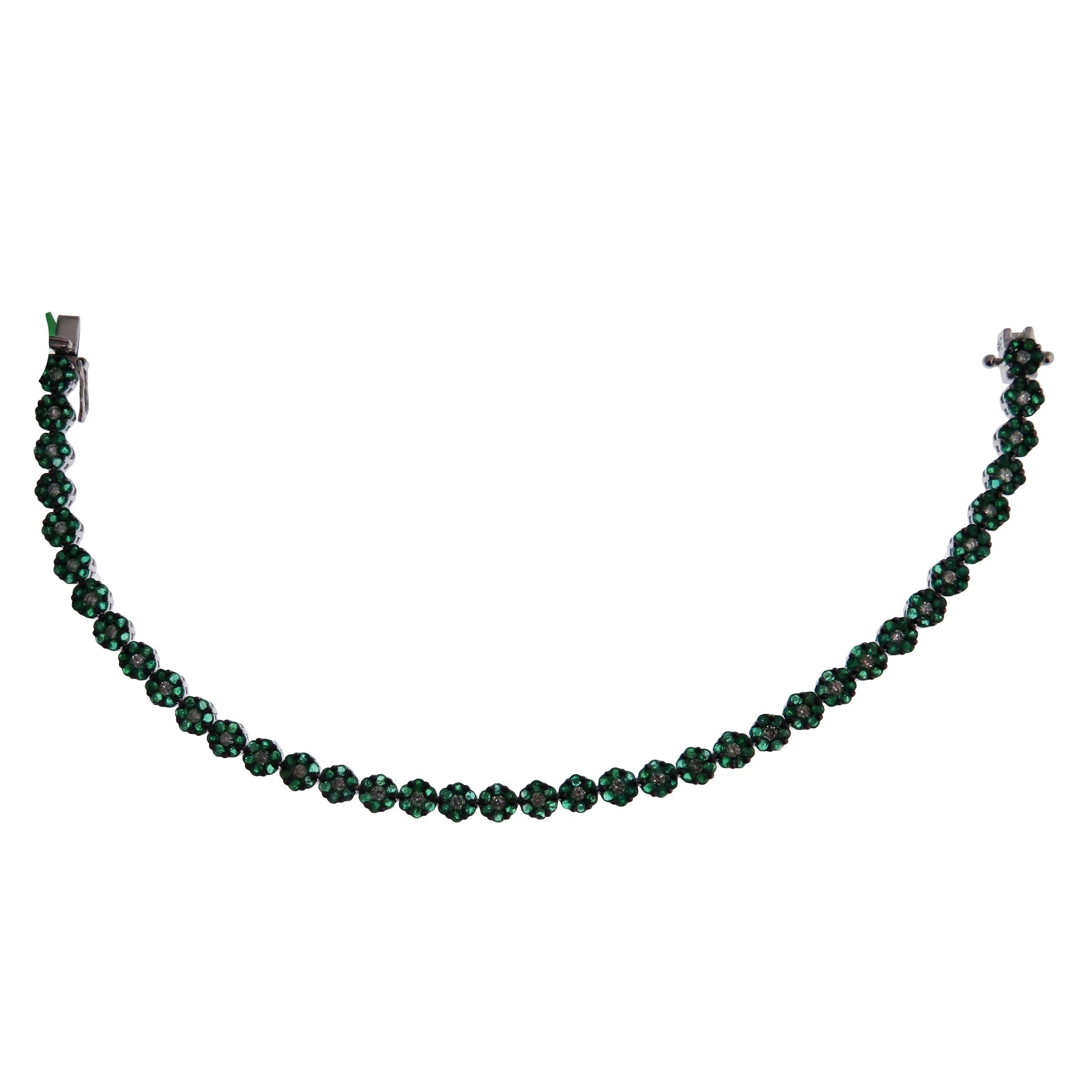 This bracelet is crafted in 18-karat white gold, weighing approximately 0.85 total carats of SI Quality white diamonds and 3.55 total carats of Emerald stones. Beautiful black rhodium accent on the bracelet. 

Bracelet is approximately 7