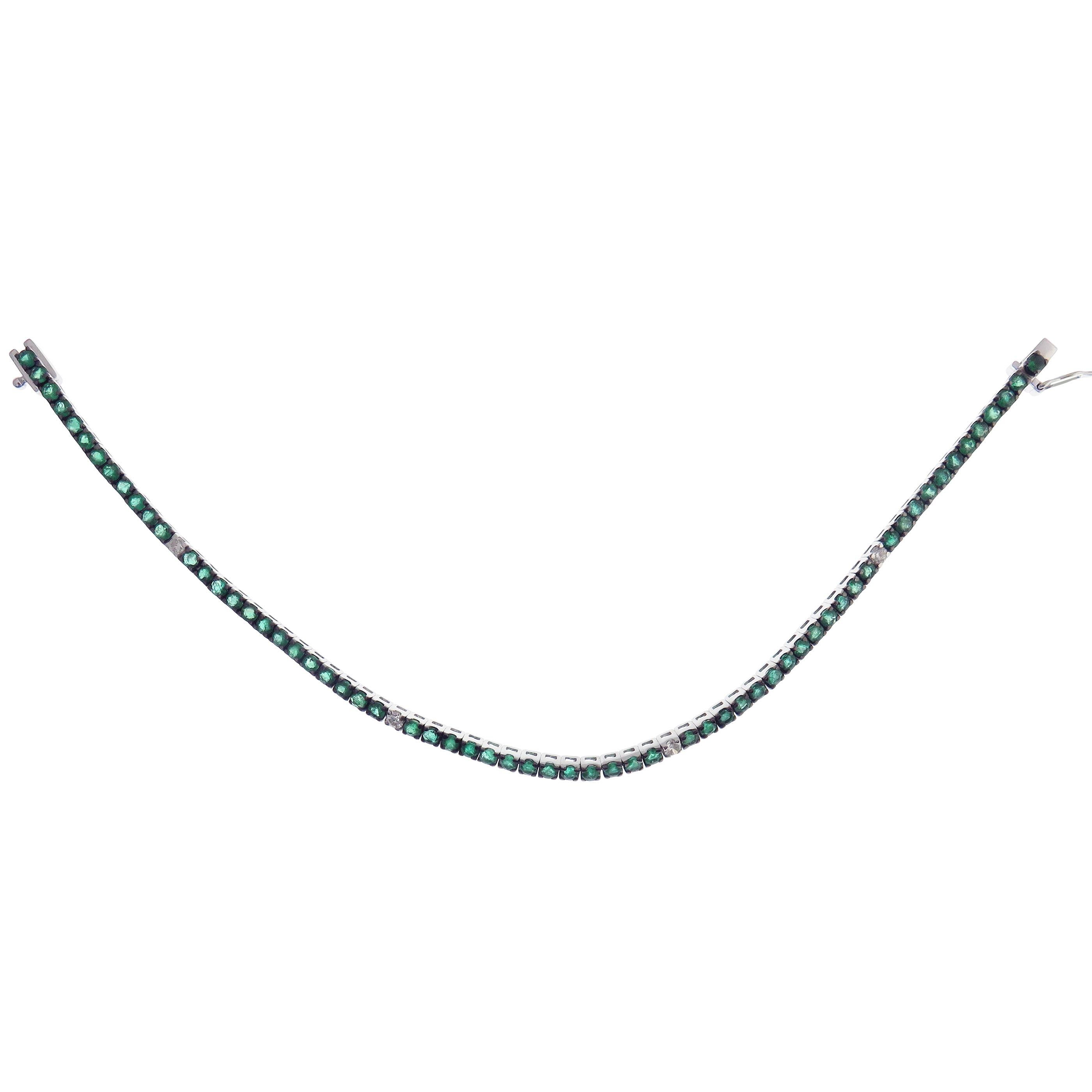 This bracelet is crafted in 18-karat white gold, weighing approximately 0.20 total carats of SI Quality white diamonds and 3.30 total carats of Emerald stones. 

Bracelet is approximately 7