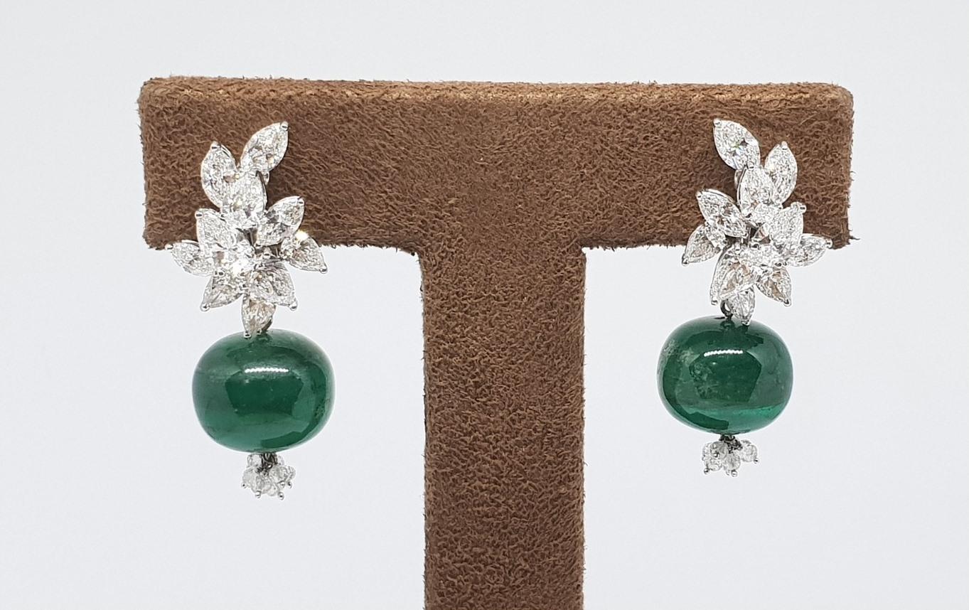 A simple cluster where brilliant cut marquise & pear shape diamonds are set in an interplay of levels. The non-faceted natural & almost identical  Zambian emerald melon beads with a  tassel of natural diamond beads compliment each other in these